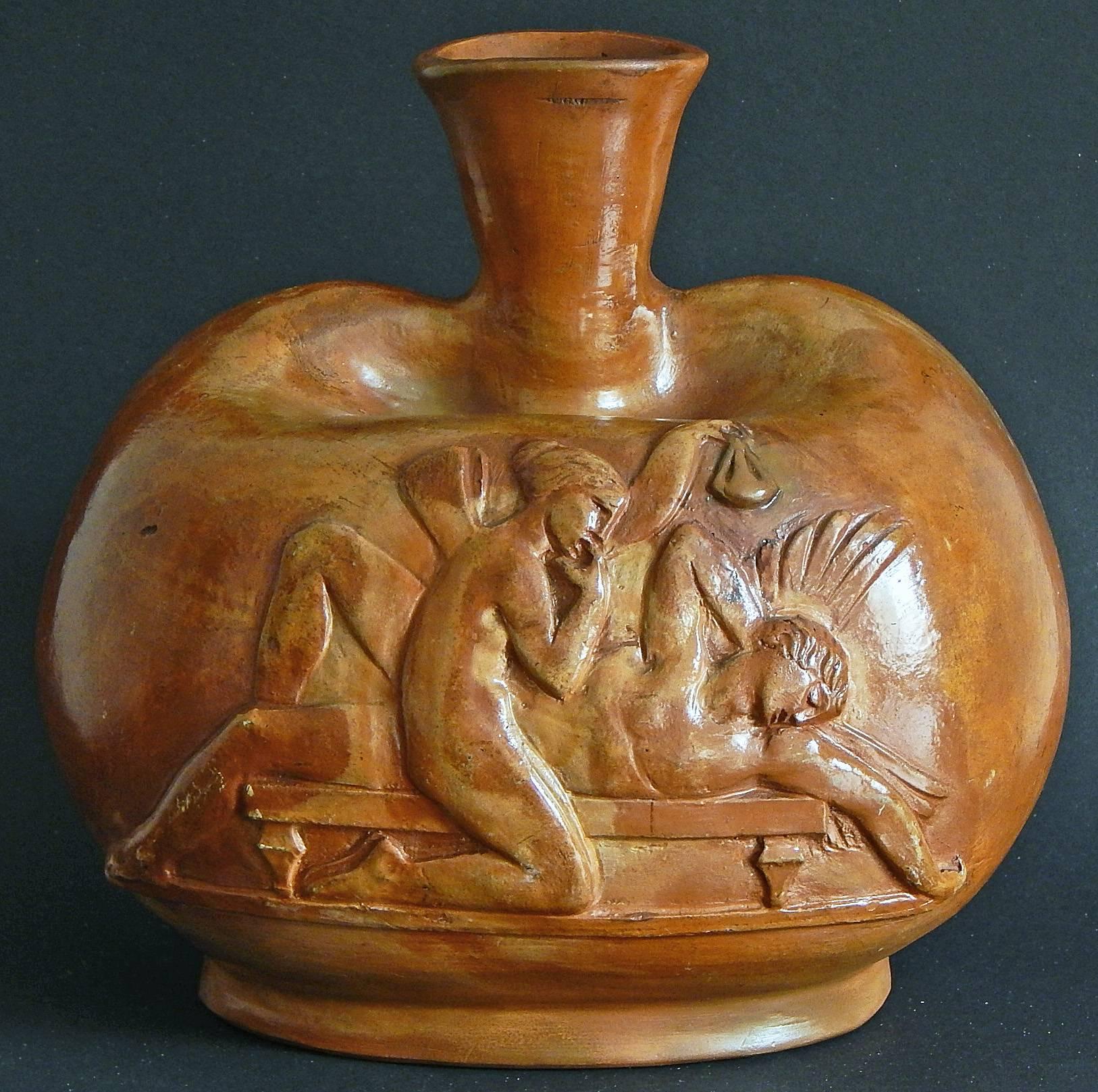 A fine and remarkable example of Art Deco sculpture, this vase is adorned on two sides with scenes from the mythological stories of Psyche and Cupid, carved into the clay not molded by Danish master Jens Jakob Bregnoe. The artist is best known for a