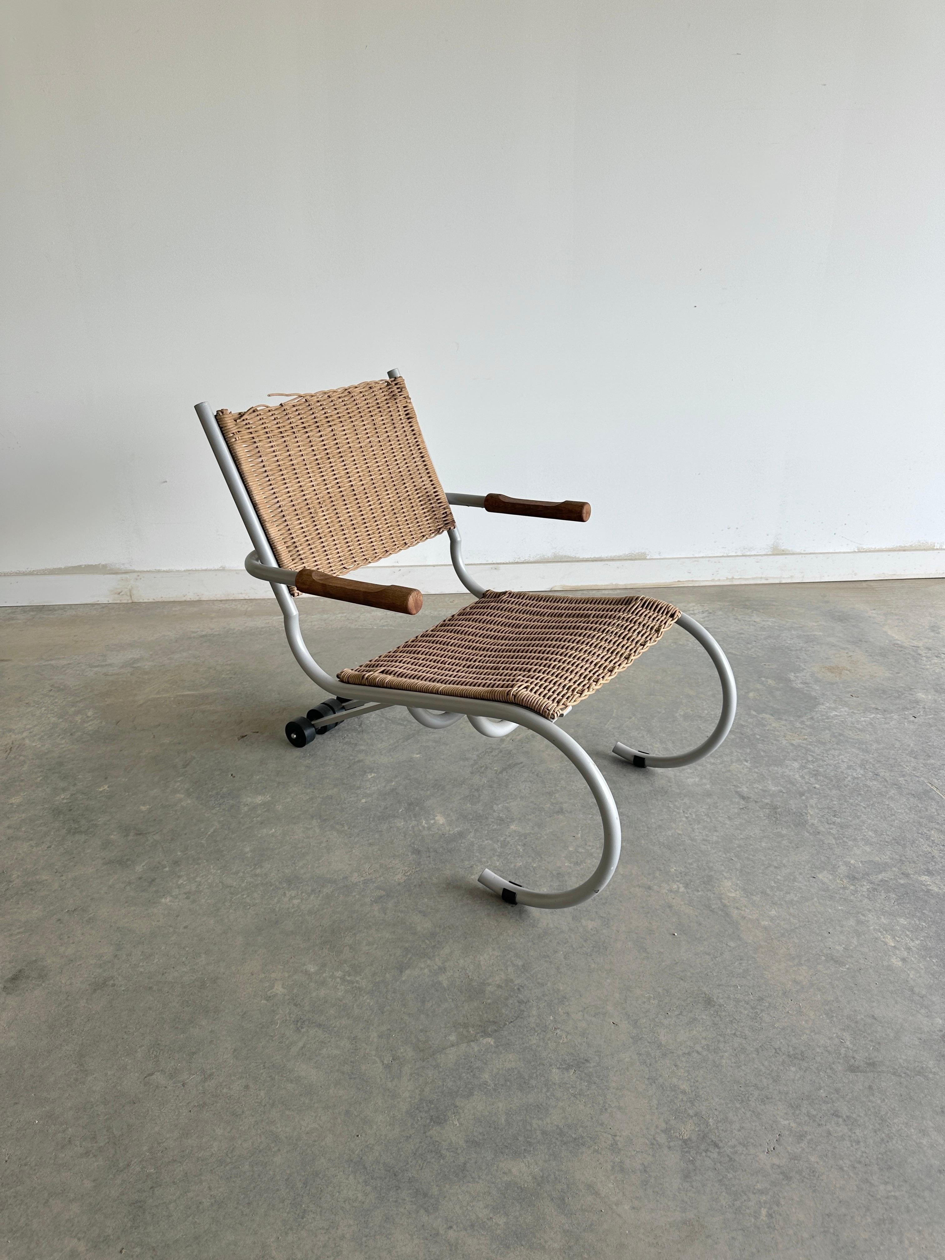 The PT Skate Lounger Chair was designed by Paul Tuttle for Strässle International in the 1960s. The chair features a cantilevered steel frame with wicker seat and backrest and rolling skateboard wheels at the back. 

The entire PT Skate series is