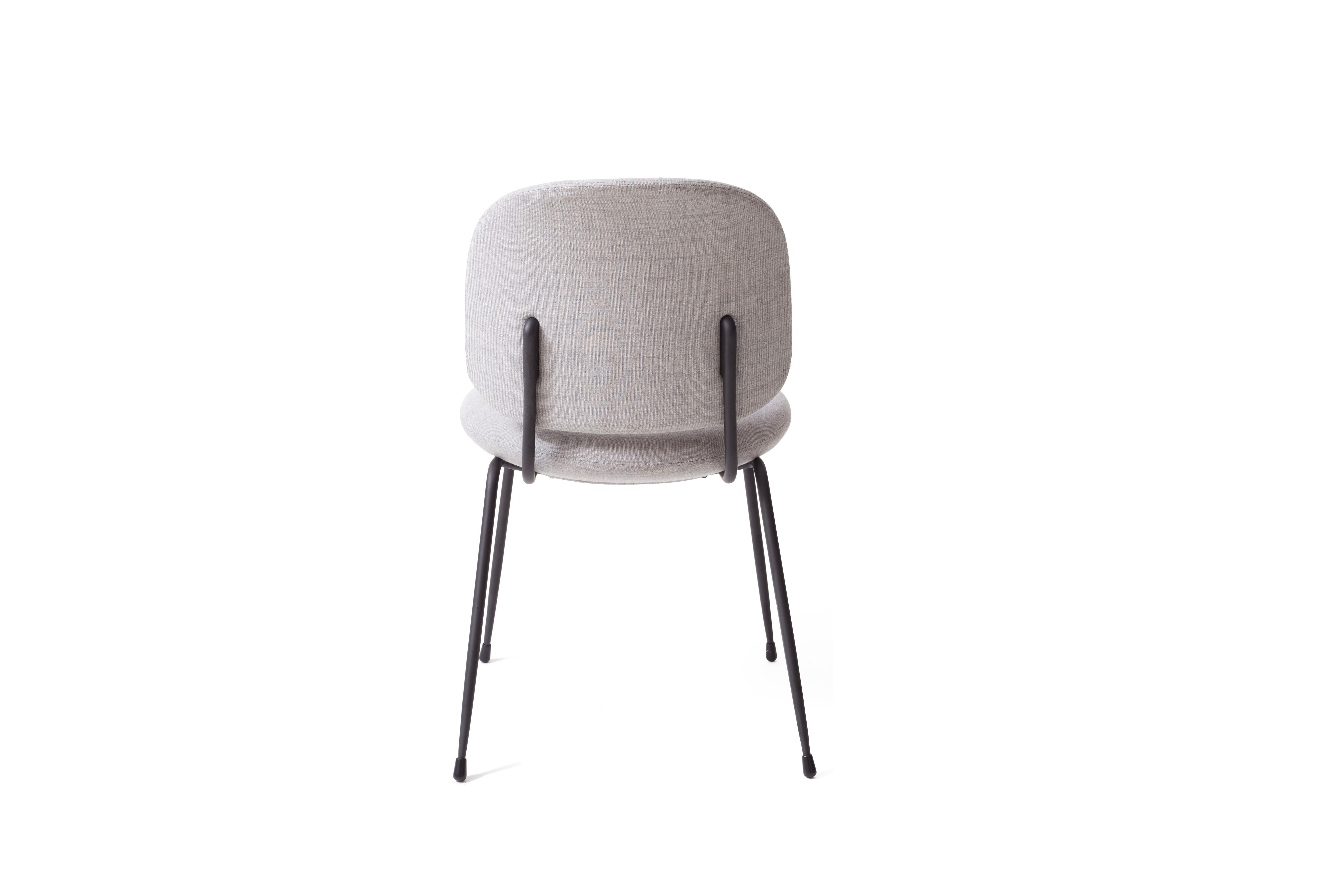 The industry dining chair by Stellar Works has a sculptural feel that is at home in a range of locations. This utilitarian-inspired chair balances a comfortable, upholstered back and seat cushions with the bold nature of steel, while the lack of