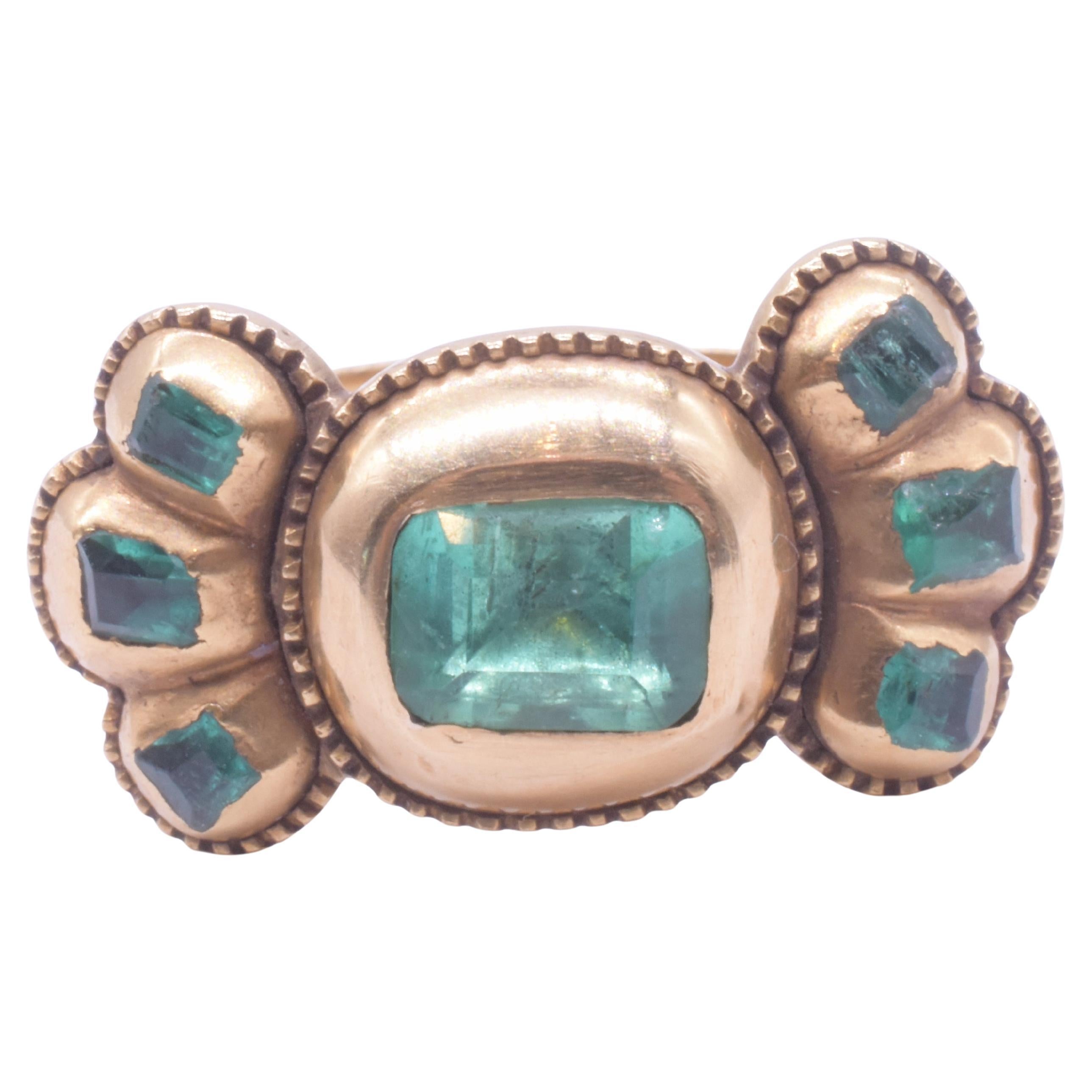 C1690 Iberian 7 Stone Table Cut Emerald Bow Form Ring For Sale