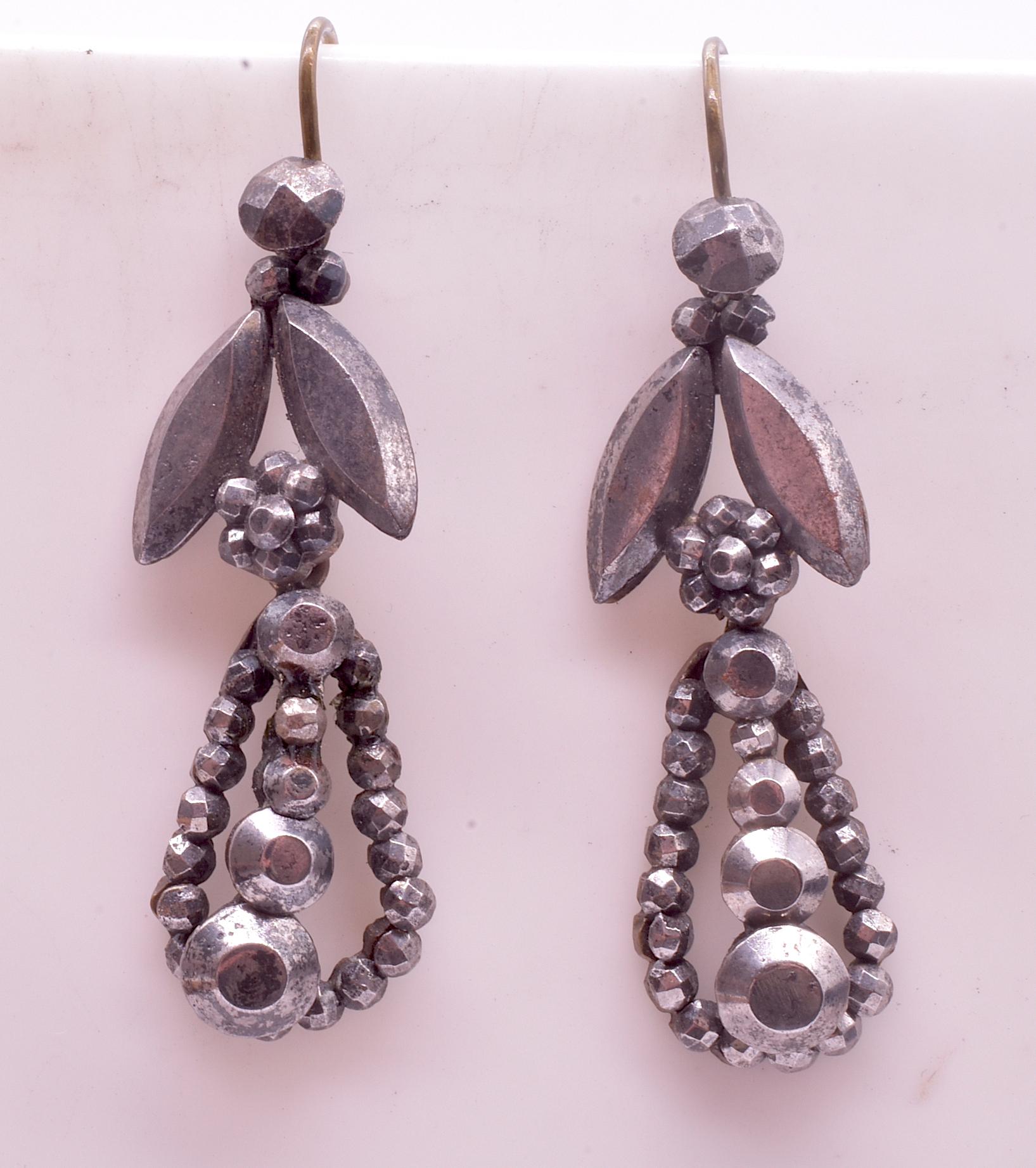 Sparkling Victorian cut steel earrings with faceted balls, leaves and circles. Cut steel was popular in England for its luster and shine in candlelight. Each tiny stud is hand cut and embedded in a metal base plate. Cut steel was the only form of
