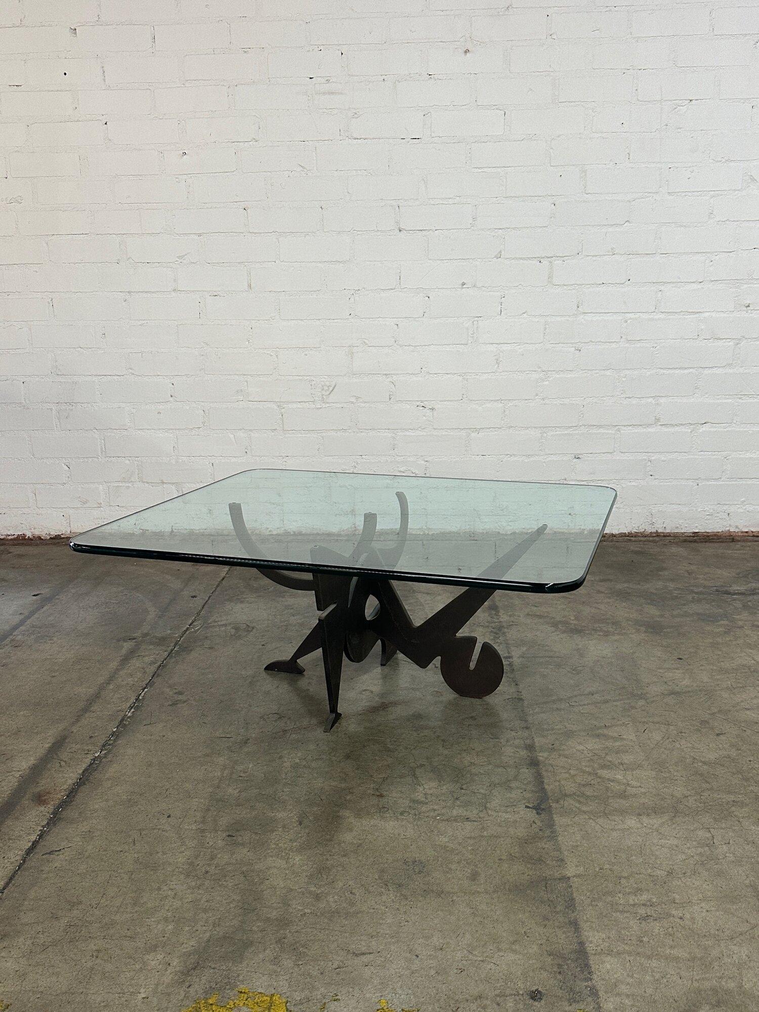 W42 D36 H17.5

Rare well preserved Post Modern French coffee table.  Table base interlocks two pieces of heavy thick iron. This glass surface is well preserved with no visible chips or breaks. 