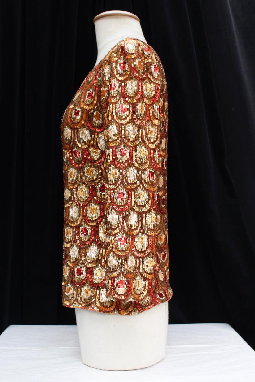 Pucci (Made in Italy) - Jersey top embroidered with sequins, lined with light brown silk chiffon. Indicated size 38FR.

Additional information:
Dimensions: Shoulders: 41 cm (16.14