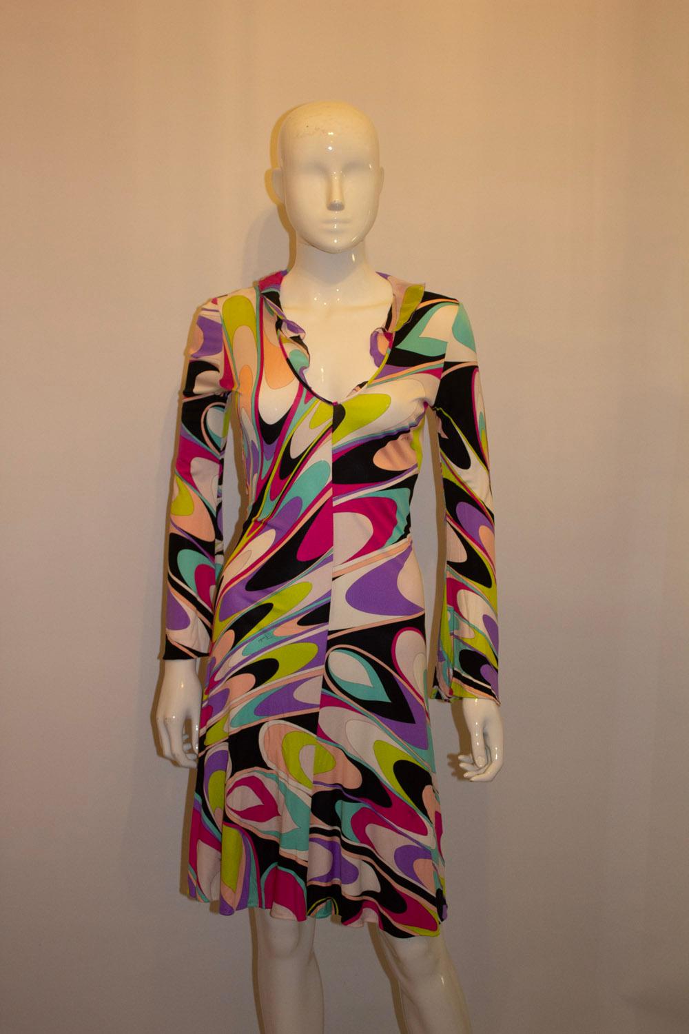 A wonderful summer dress by Pucci. In a super quality silk jersey and iconic multi colour Pucci print.
The dress has a v neckline with silk frill detail ( can be turned in or removed), and slips over the head. 
UK size 8 , Bust up to 35'' , length