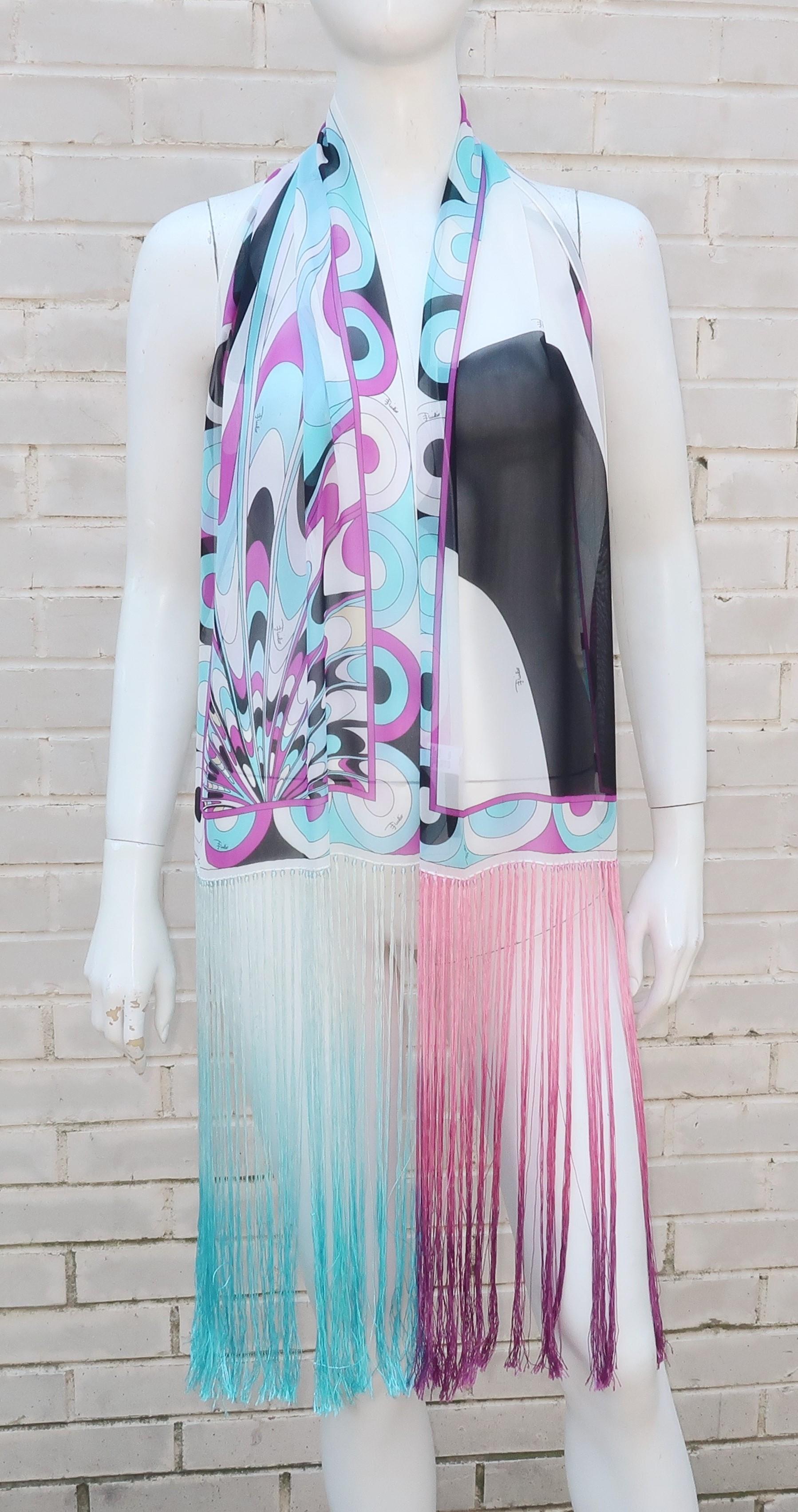 This is a fun Emilio Pucci scarf design with a great combination of an iconic psychedelic print and long boho chic fringe worthy of a rock star.  The semi sheer silk chiffon is in shades of black, white, aqua, gray and purple.  The fringe on each