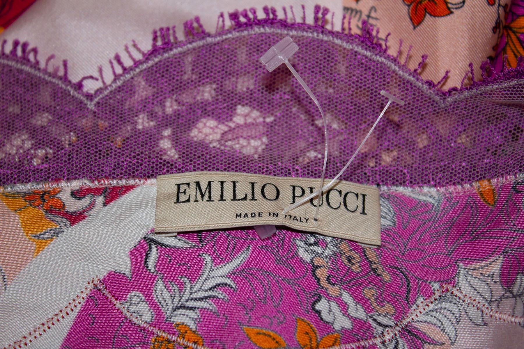 A very pretty silk top by Pucci, in a red and purple print with lace edging. The top has a v neckline, 8'' slits on either side , and the logo detailed in the fabric. 
UK size 8 Measurements Bust up to 36'', length 30''