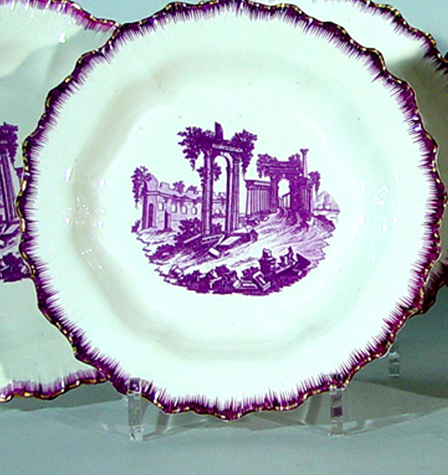 The Neale & Co. puce-colored shell-edge plates are each decorated in a purple transfer with figures in the foreground amongst a landscape of Classic ruins. The rims, also with a feathered puce (purple) border, are highlighted with unusually strong