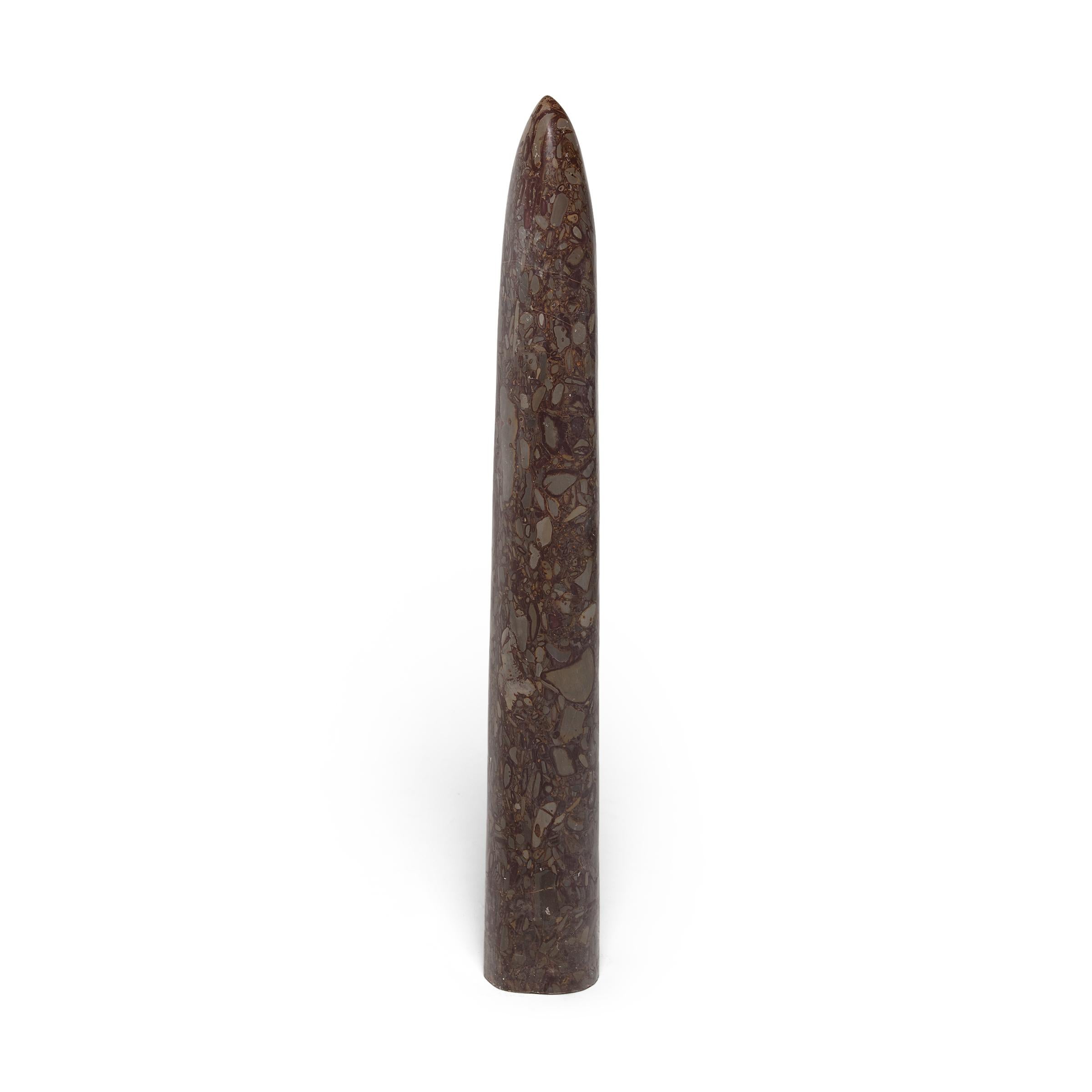 Carved from a single block of puddingstone, this stone obelisk makes for a striking addition to a garden or interior as a Minimalist modern sculpture. Though it looks like a meticulous painting, the mesmerizing pattern of puddingstone is actually