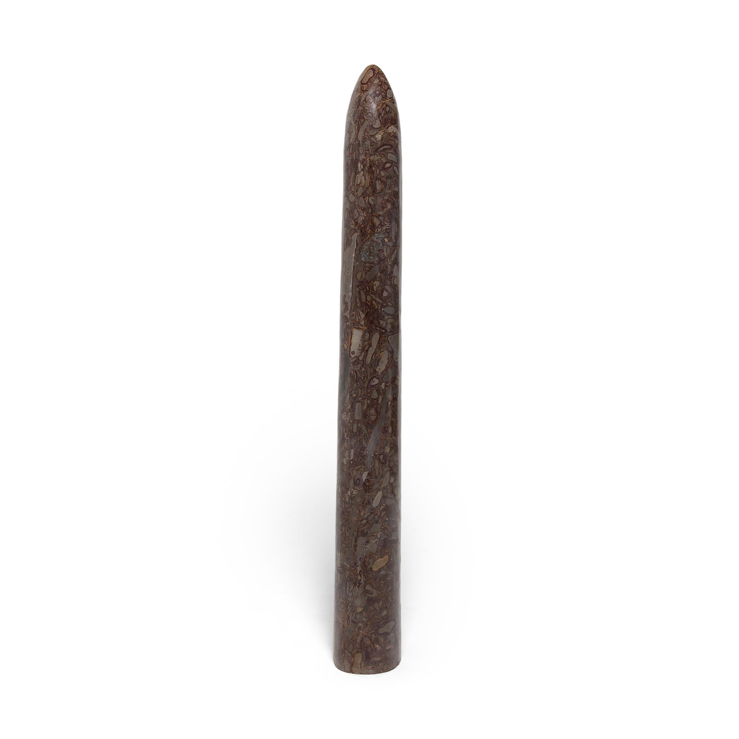 Carved from a single block of puddingstone, this stone obelisk makes for a striking addition to a garden or interior as a minimalist modern sculpture. Though it looks like a meticulous painting, the mesmerizing pattern of puddingstone is actually