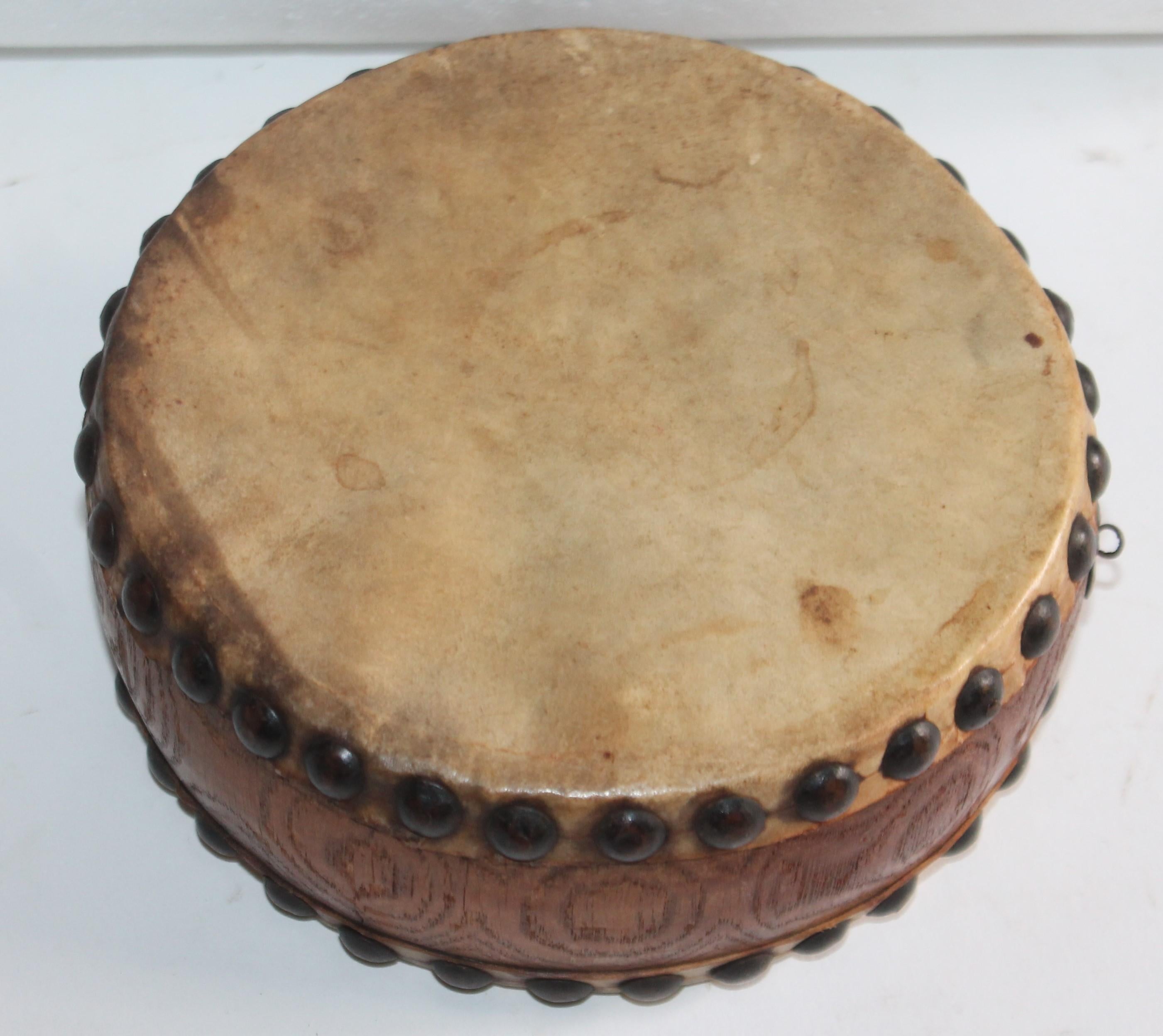 Small and early handmade hide covered drum. Probably made for a child or a Indian. Possibly Native American.