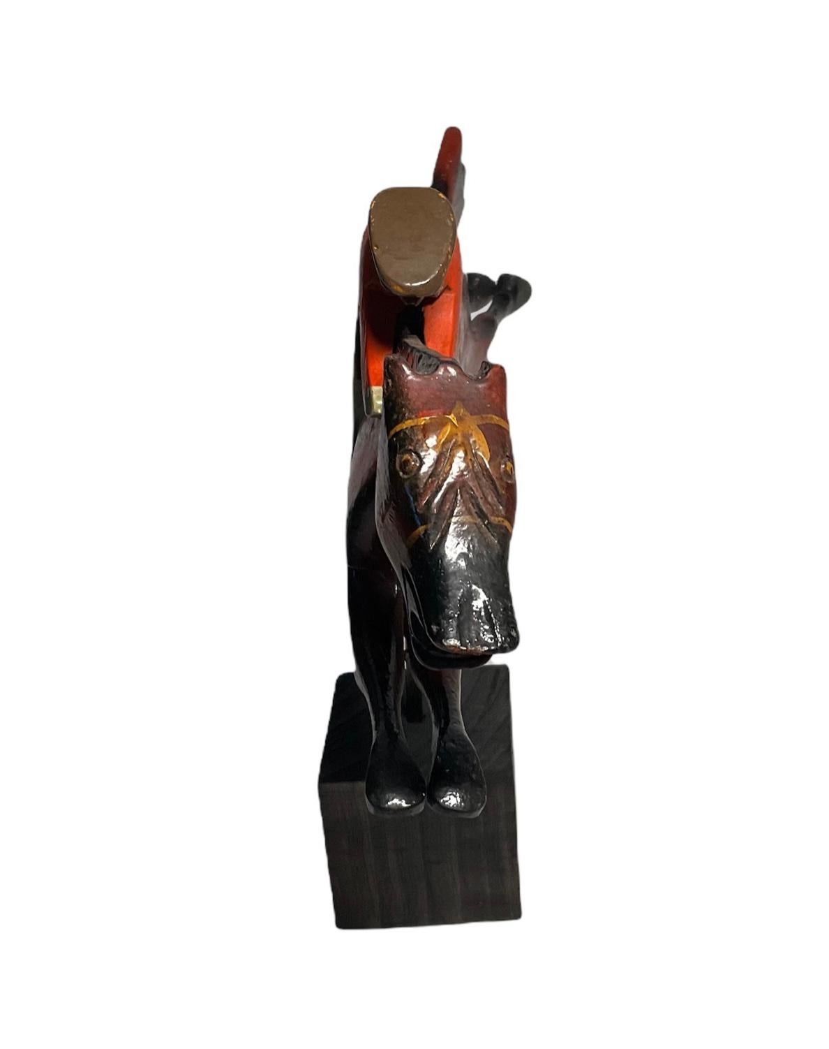 This is a wood hand crafted sculpture of a jockey and a horse made by Puerto Rican’s craft-men with wood from the island. The sculpture is made in three parts- the jockey with the front upper part of the horse, the legs and then, the tail. After