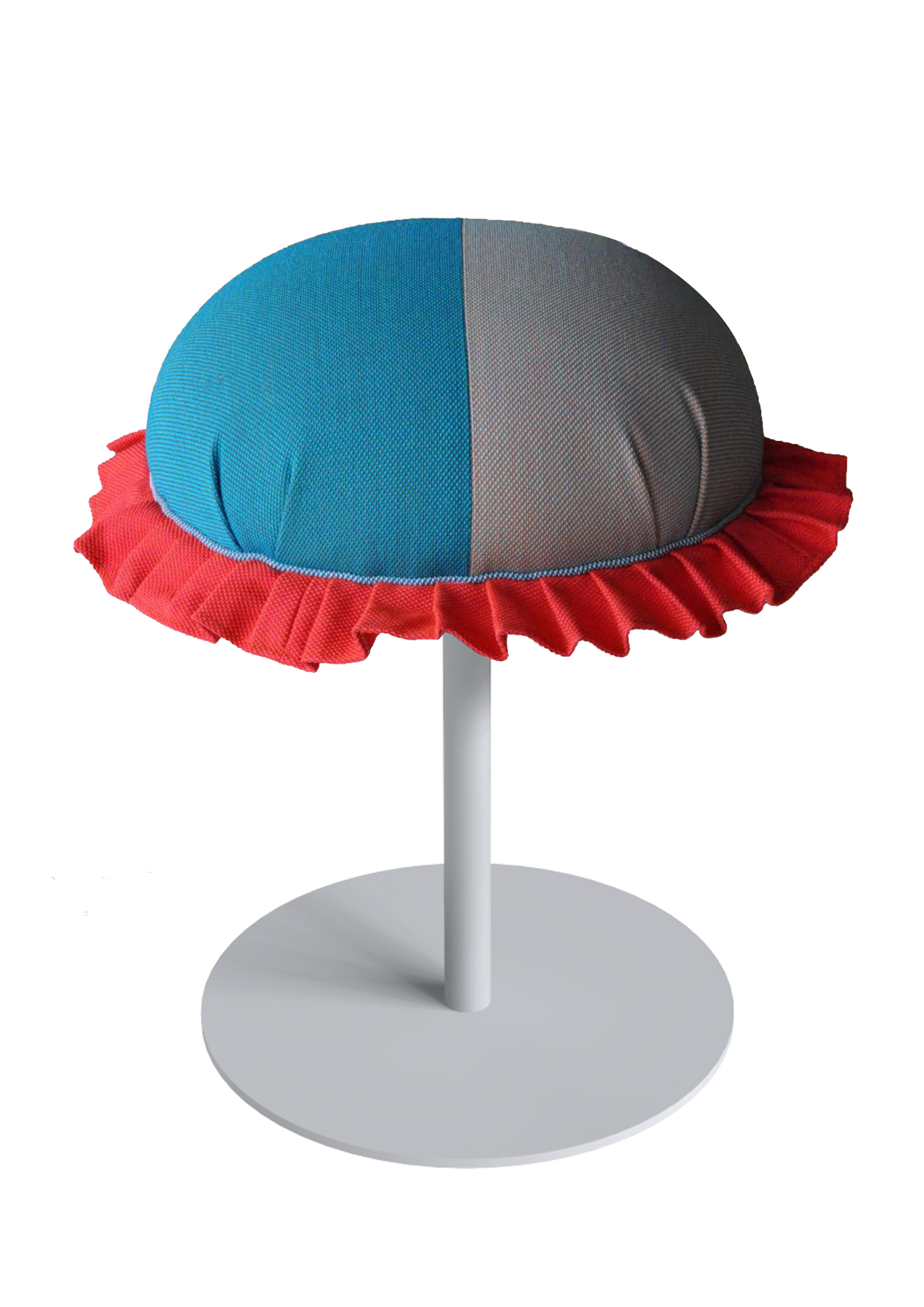 puff-puff by Sema Topaloglu.
This pouf has iron-coated legs and cloth upholstery.
With different colour options. 
Fabric is specifically chosen as art-craft material and has local feeling.
puff-puff is a contemporary piece which brings happiness
