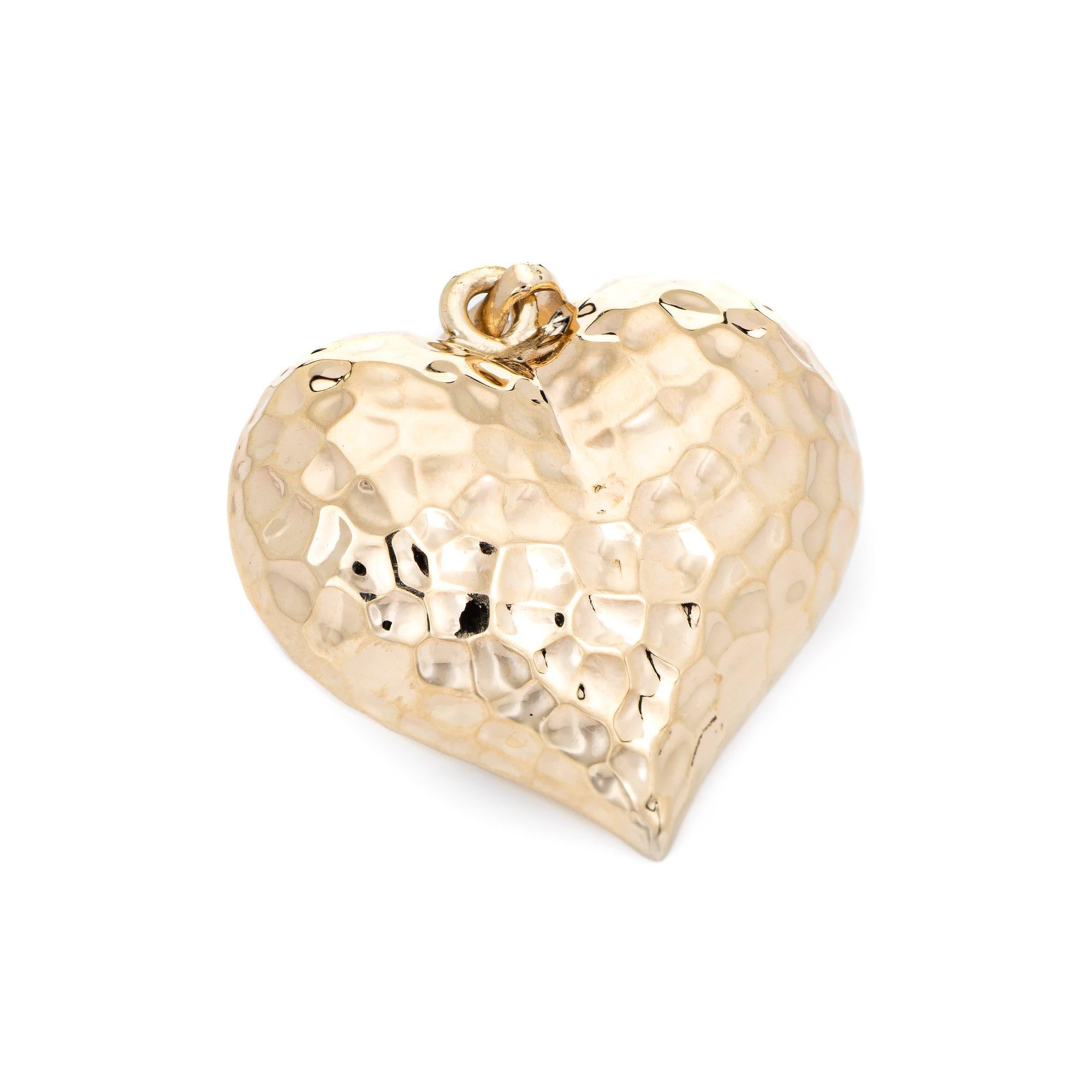 Stylish and finely detailed double sided puffed heart pendant crafted in 14k yellow gold.

The pendant is double sided with a hammered design. The pendant is hollow and has a lightweight feel. Ideal for wear as a pendant on a necklace or on a charm