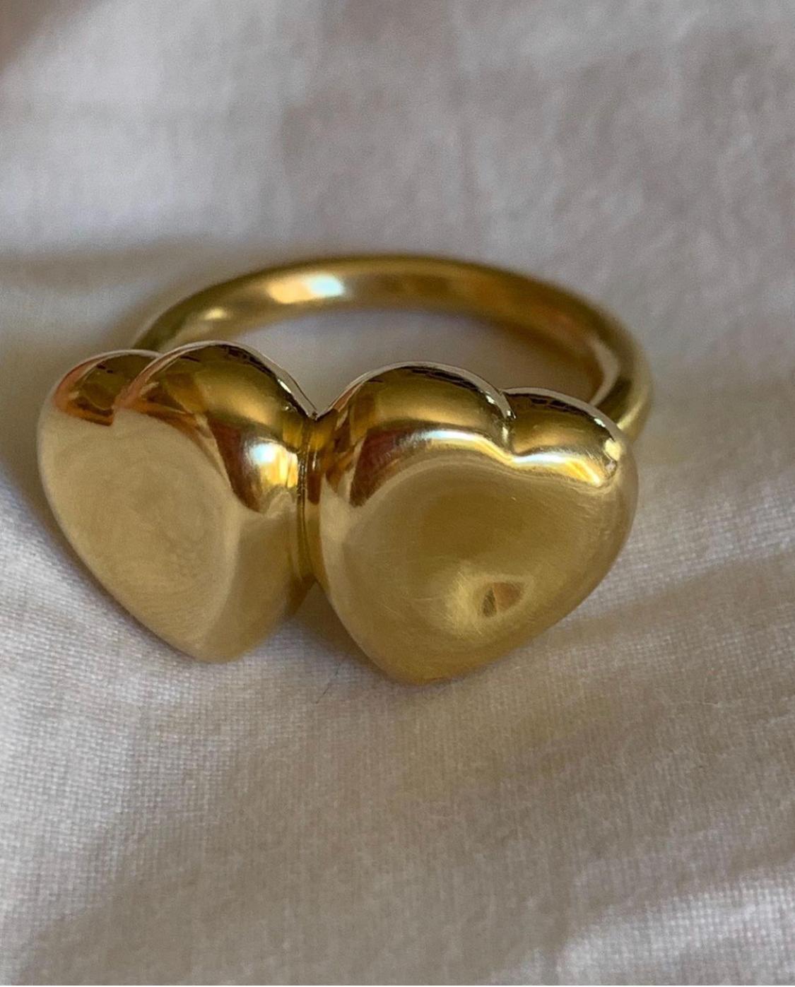 The puffy double heart ring is designed by Christina Alexiou.
This ring is crafted with 18k gold and is made in Greece. The hearts are hollow, thus makes it an easy-to-wear everyday piece of jewelry. The design of this ring features the element of a