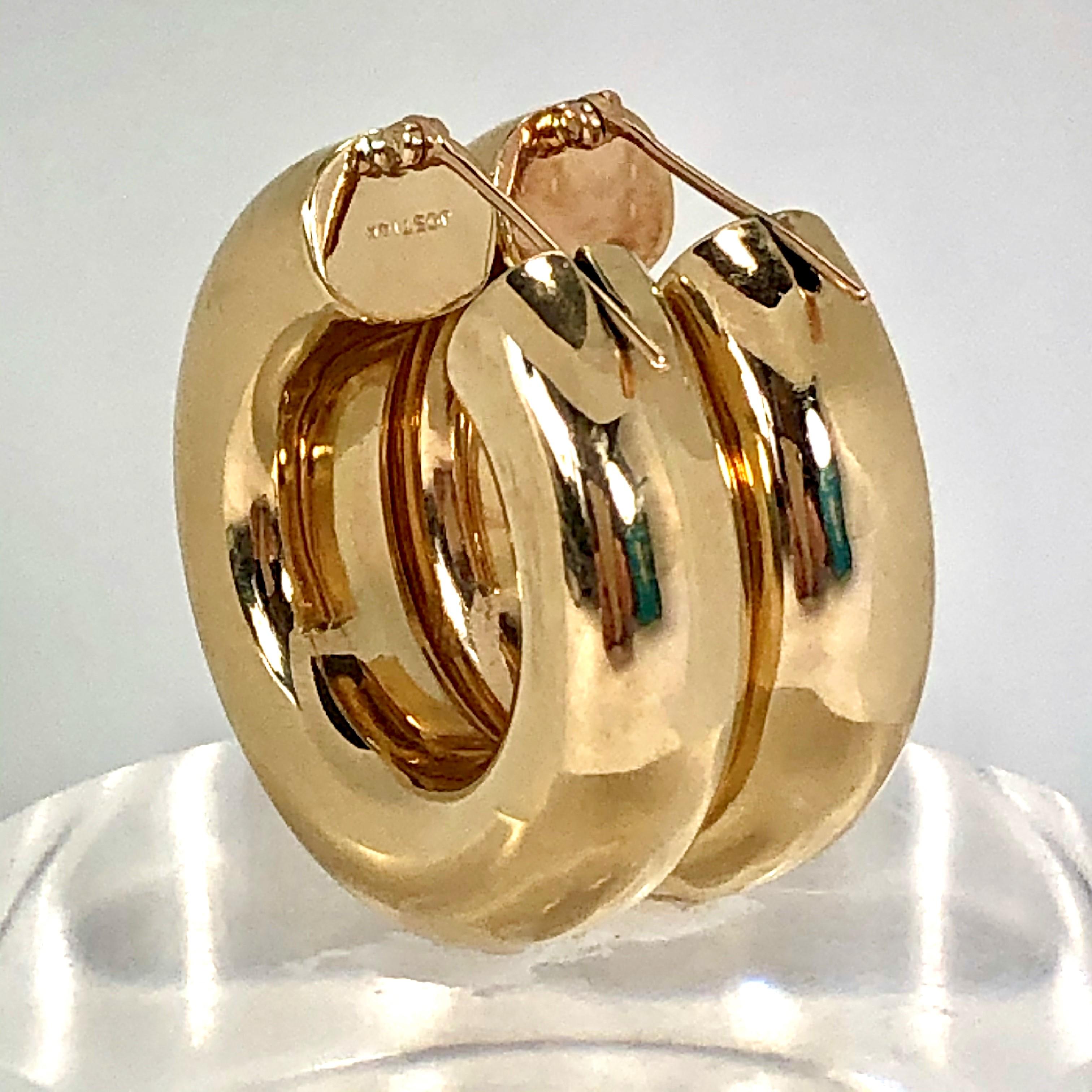 Made of 14K Yellow Gold, these wide hoop earrings make a great addition to 
your everyday jewelry collection. Measuring 1  1/4 inch diameter by 5/16 inch 
thick. Signed JOST 14K. Gross weight 11.4 grams.