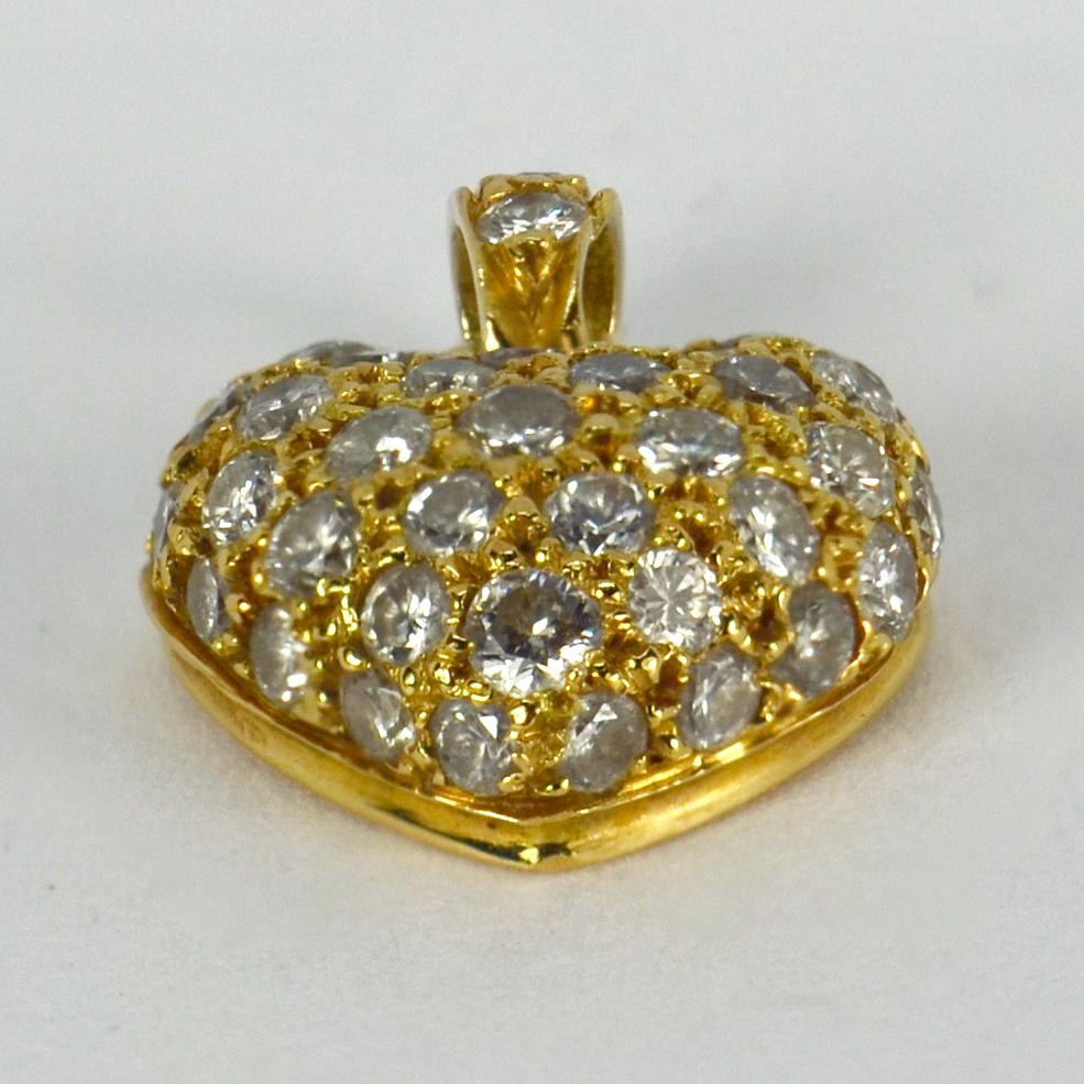 An 18 karat (18K) yellow gold charm pendant designed as a puffy heart set with 45 white round brilliant cut diamonds. Unmarked for gold but tested as 18 karat, with a partial French makers’ mark.

Total diamond weight: approximately 0.45