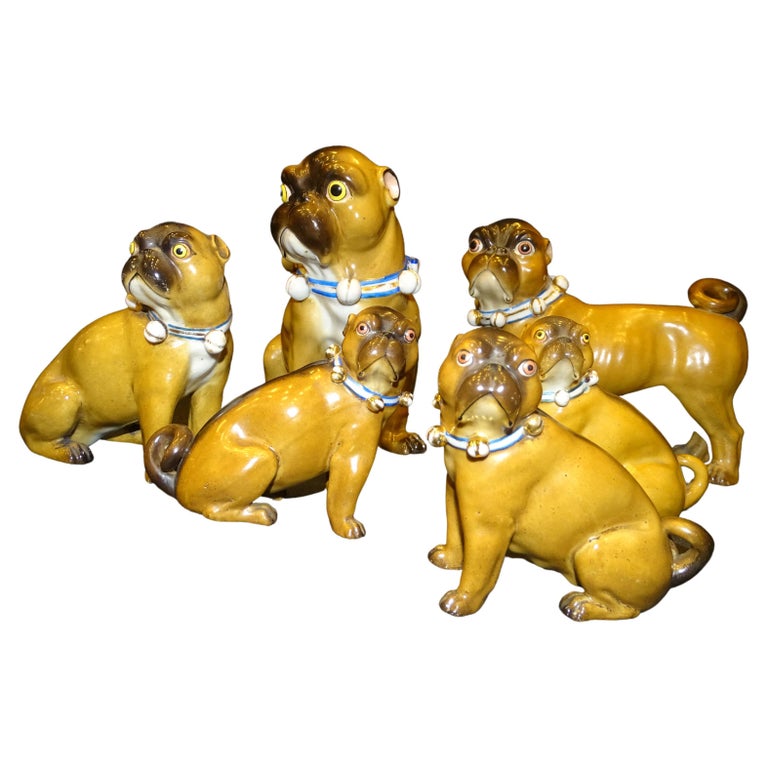 A beautiful set of 19th century Conta and Boehme porcelain figures of a pug dogs family, with gilt belt collars. Each pug is exceptionally hand-carved and hand-painted to seem as realistic as possible. With an amazing multi-toned brown overcoat fur,