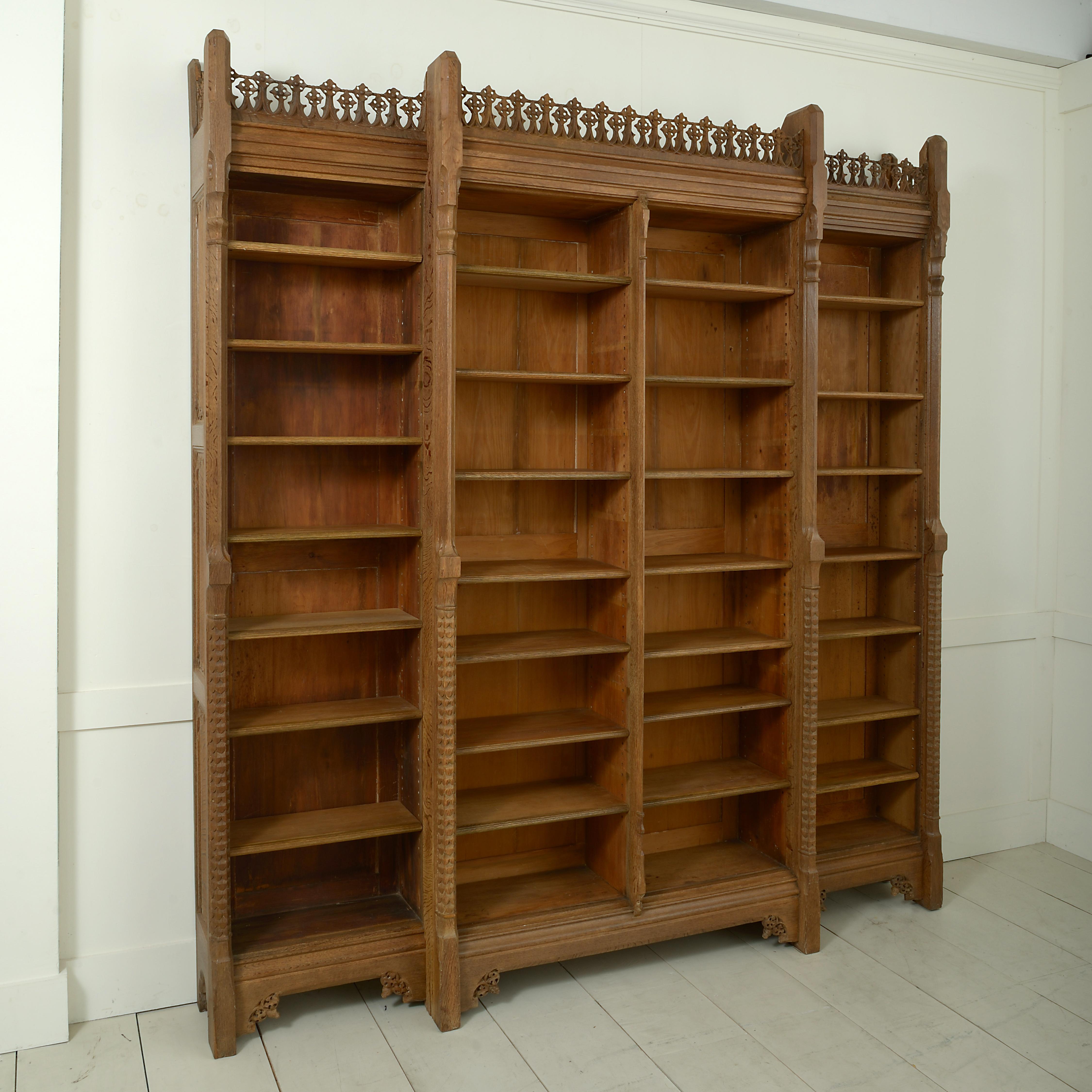 An early Victorian oak breakfront open bookcase, the design attributed to A.W.N Pugin and the manufacture to J.G. Crace, circa 1850.

Literature:
Mark Girouard, The Victorian Country House, 1979, illustrated pl. 156
These tables came from