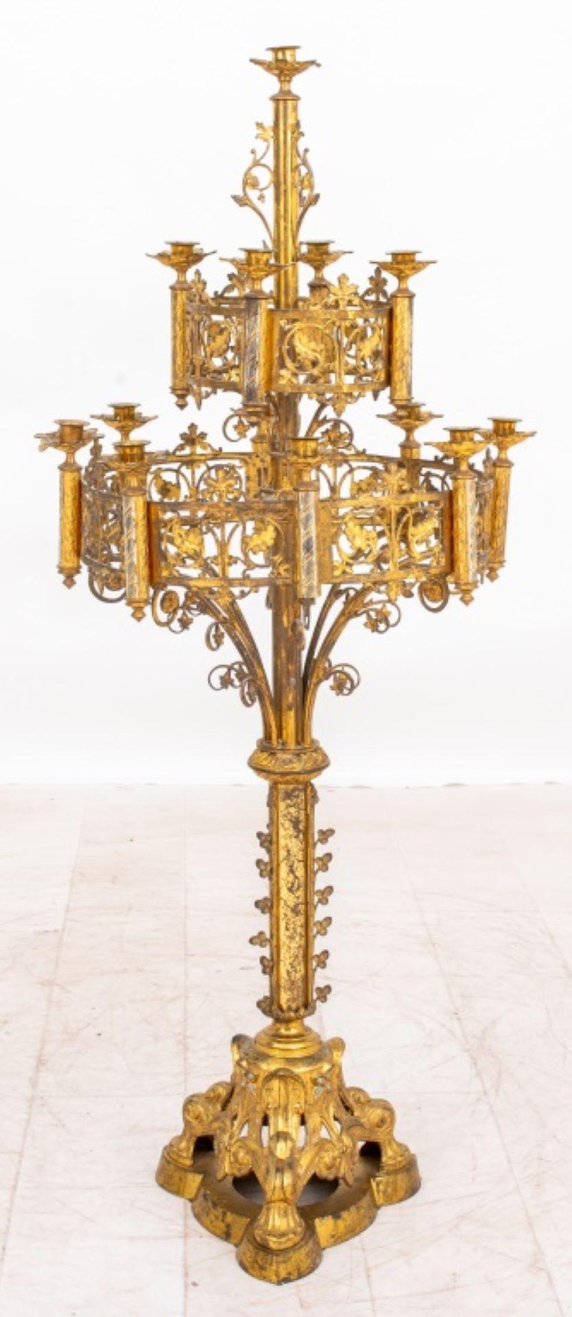 Pair of Gothic Revival Gilt Metal 13 Light Two Tiered Pedestal Candelabra, each with 13 lights in two tracery aproned tiers supported by a pedestal base, in the manner of A.W.N. Pugin (English, 1812-1852) and similar to those pictured in Designs for