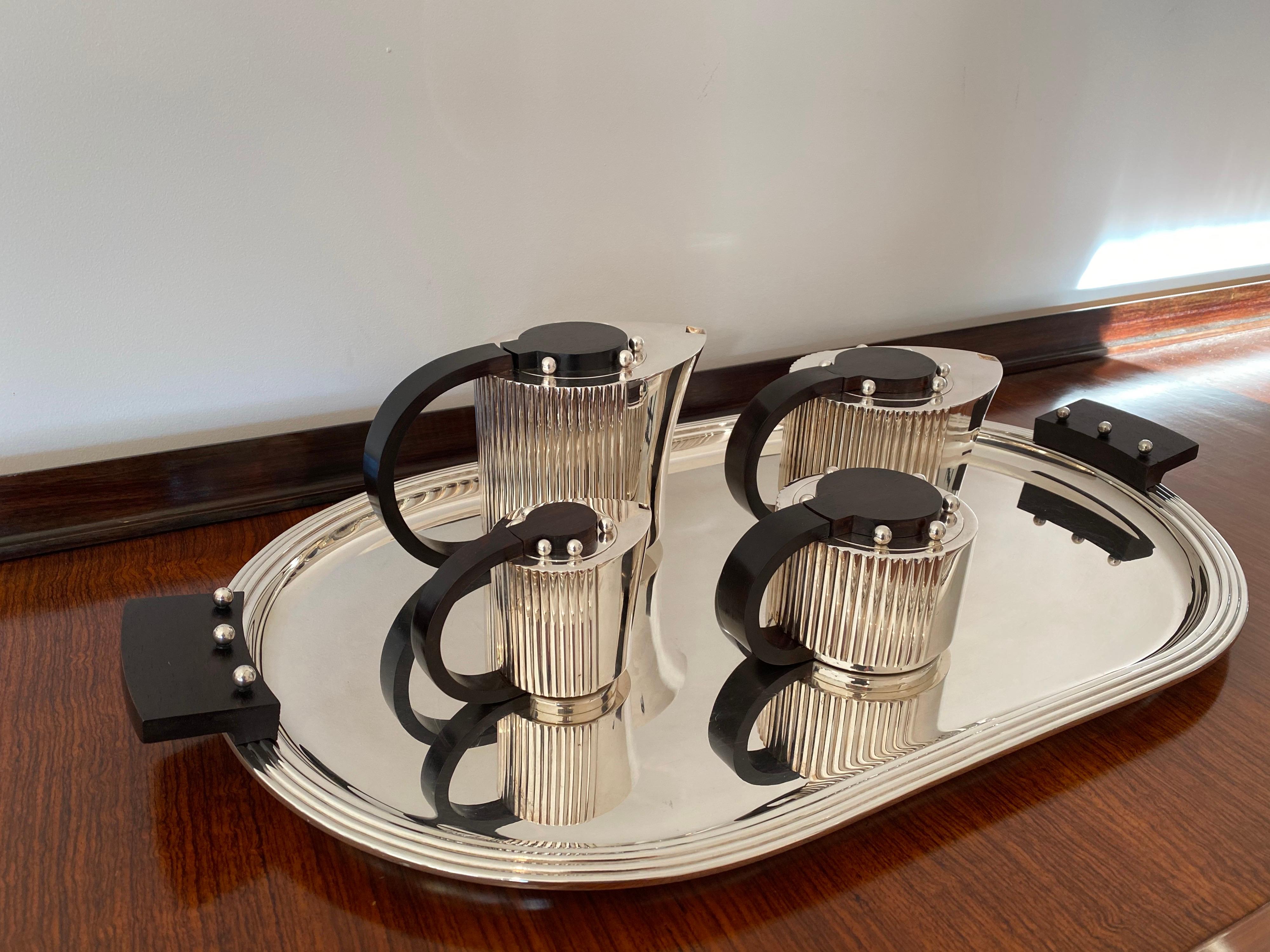 Puiforcat Etchea Art Deco tea and coffee service in silver plated metal and rosewood. The set of five includes:
Oval tray- 27.75