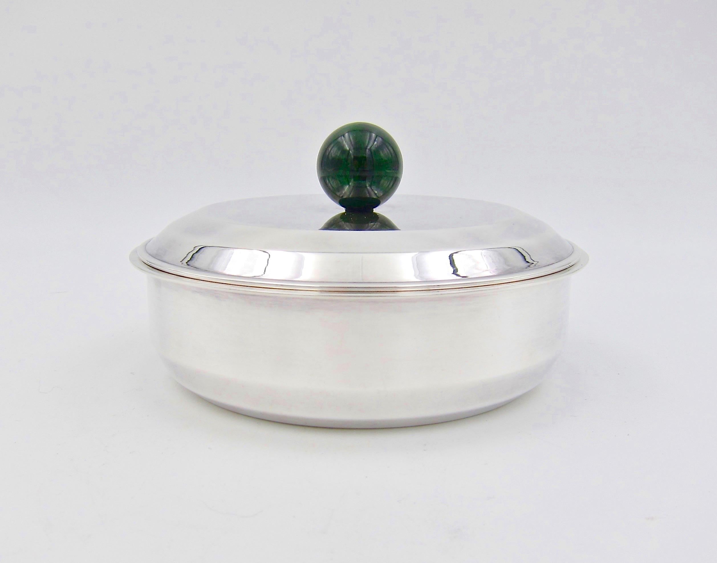 A French Art Deco bonbonnière box designed by Jean-Emile Puiforcat (1897-1945) in silver-plate with a spherical veined dark green finial, dating circa 1930s. The elegant covered box is an ideal accessory for a vanity, dresser, nightstand, or desk.