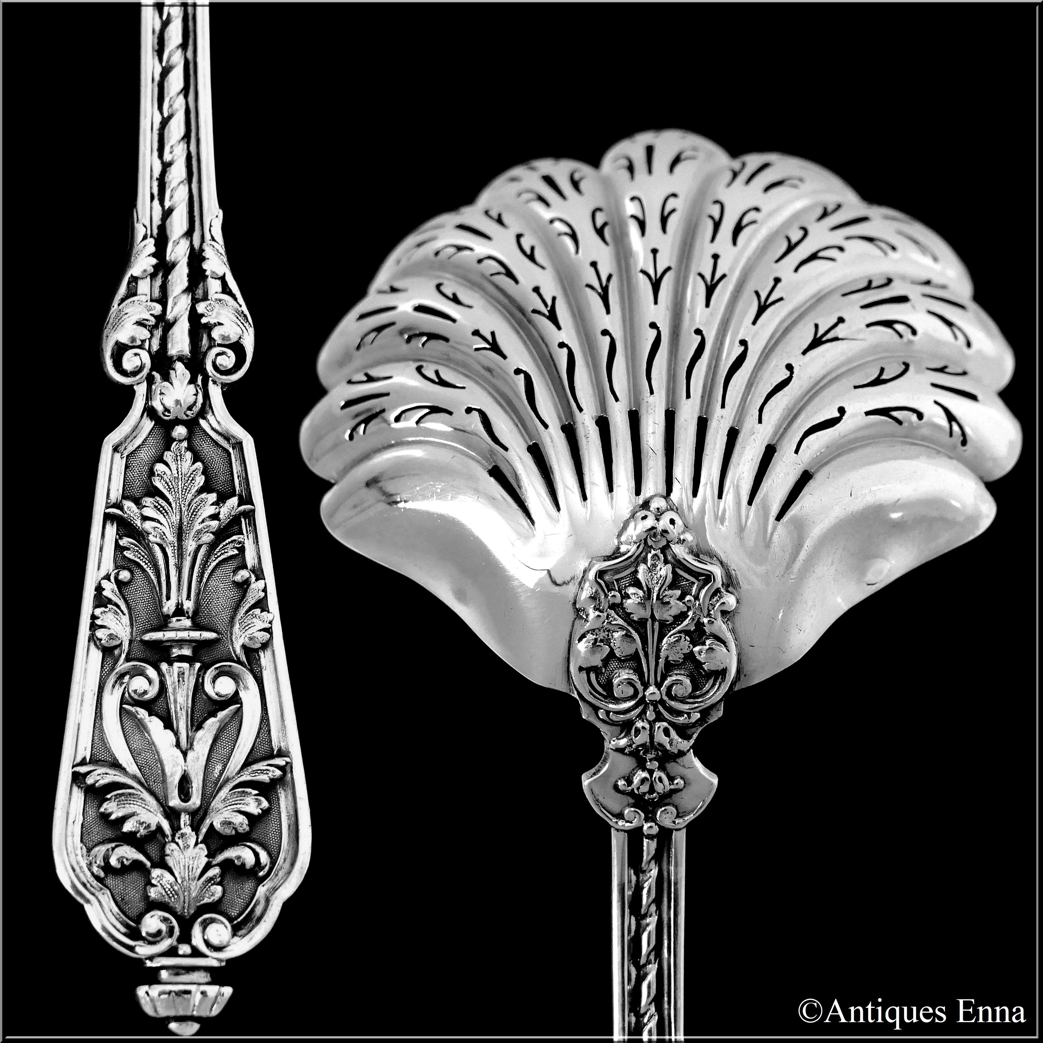 Boar's Head for 800/1000 French sterling silver guarantee.

Extremely rare model by Puiforcat for this sugar sifter spoon with stylized scallop shell bowl. The stem and pierced handle have foliage decoration in the Renaissance style on stippled
