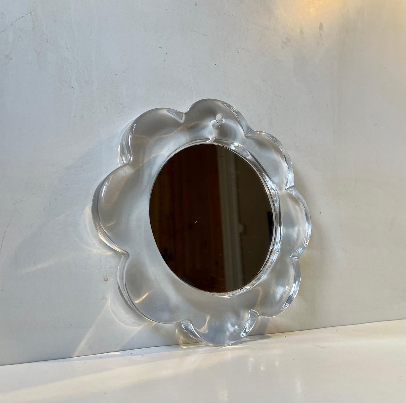 A rare small vanity type wall mirror for make-up, hair-adjustments or Decorative purposes. It is executed in thick hand-thrown art glass. Designed and made at Pukeberg in Sweden circa 1970. Measurements: 22x22 cm, Dept: 2.5 cm.