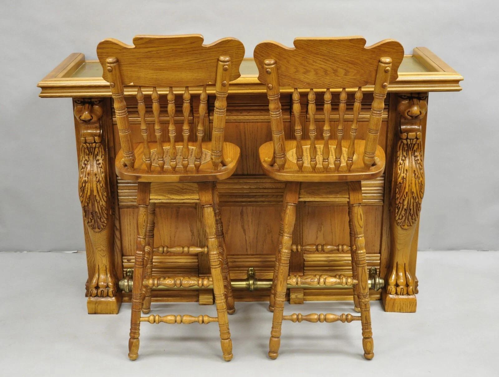 Vintage Pulaski Keepsake Collection Oak Wood Bar with Griffins and 2 Swivel Barstools - 3 Pc Set. Listing includes (1) Bar, (2) Swivel barstools with cane seats, brass bar surface, brass footrest, carved griffins, quality American craftsmanship.