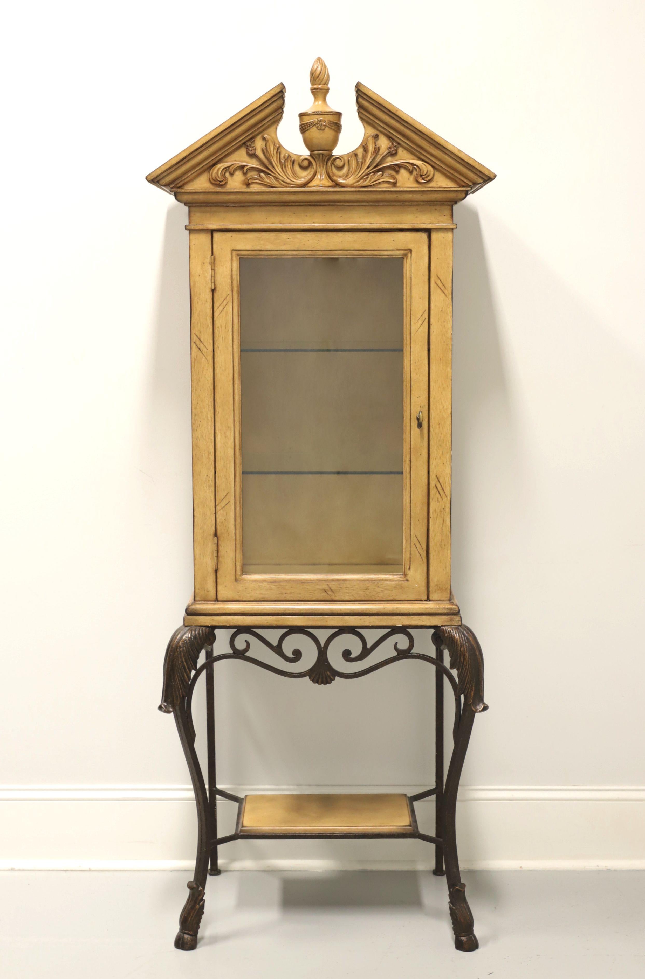 A Transitional style diminutive vitrine by Pulaski Furniture. Solid hardwood cabinet, distressed finish, brass hardware, pediment top with center finial, elevated on decorative bronze color metal base with acanthus leaves to knees, stretchers with