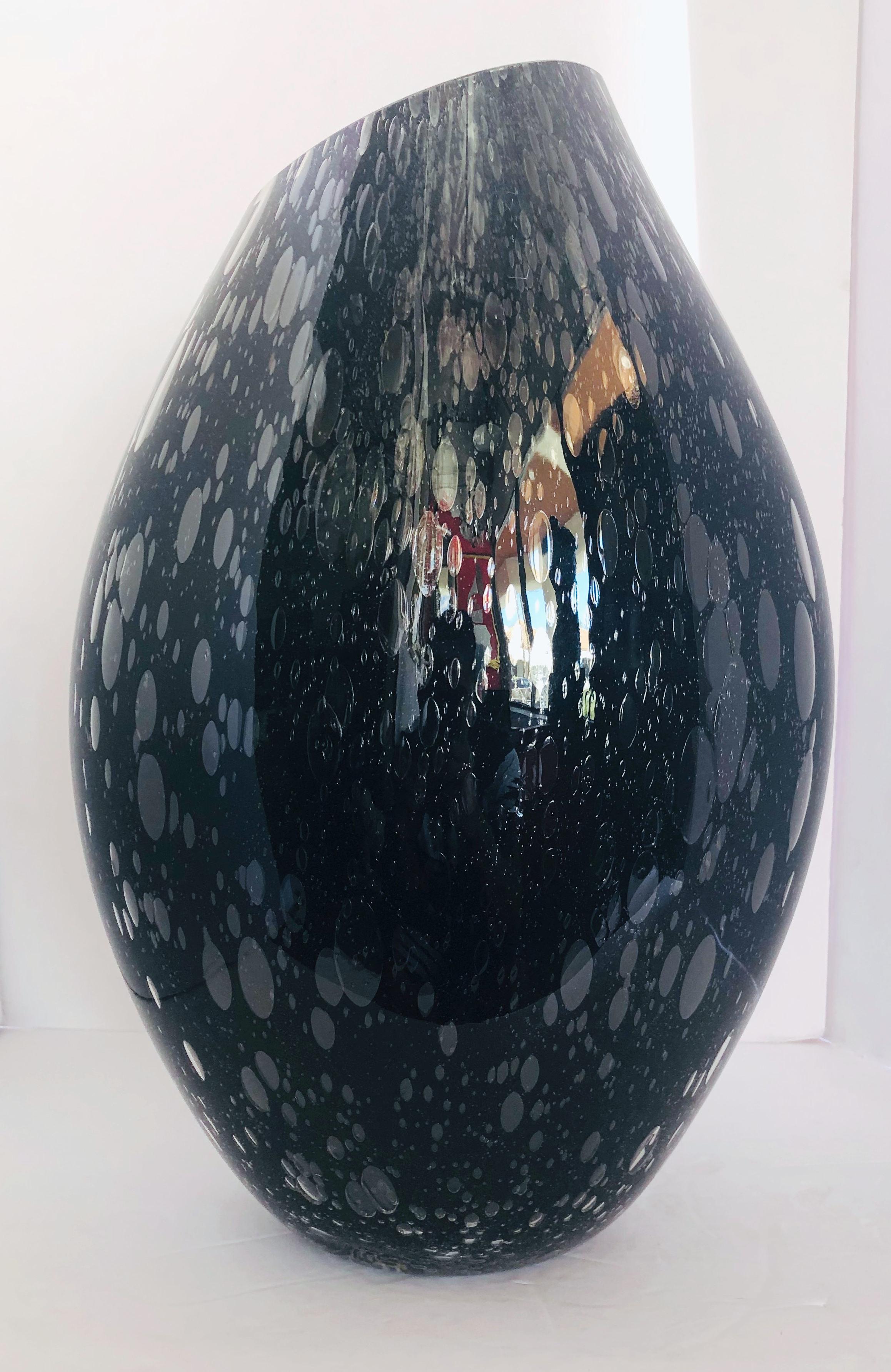 Italian vase or sculpture in thick black Murano glass blown with bubbles within the glass in Pulegoso technique by Alberto Dona for Fabio Ltd
Signature engraved on the base / Made in Italy
Height: 18 inches / Width: 12 inches / Depth: 8.5 inches 
1