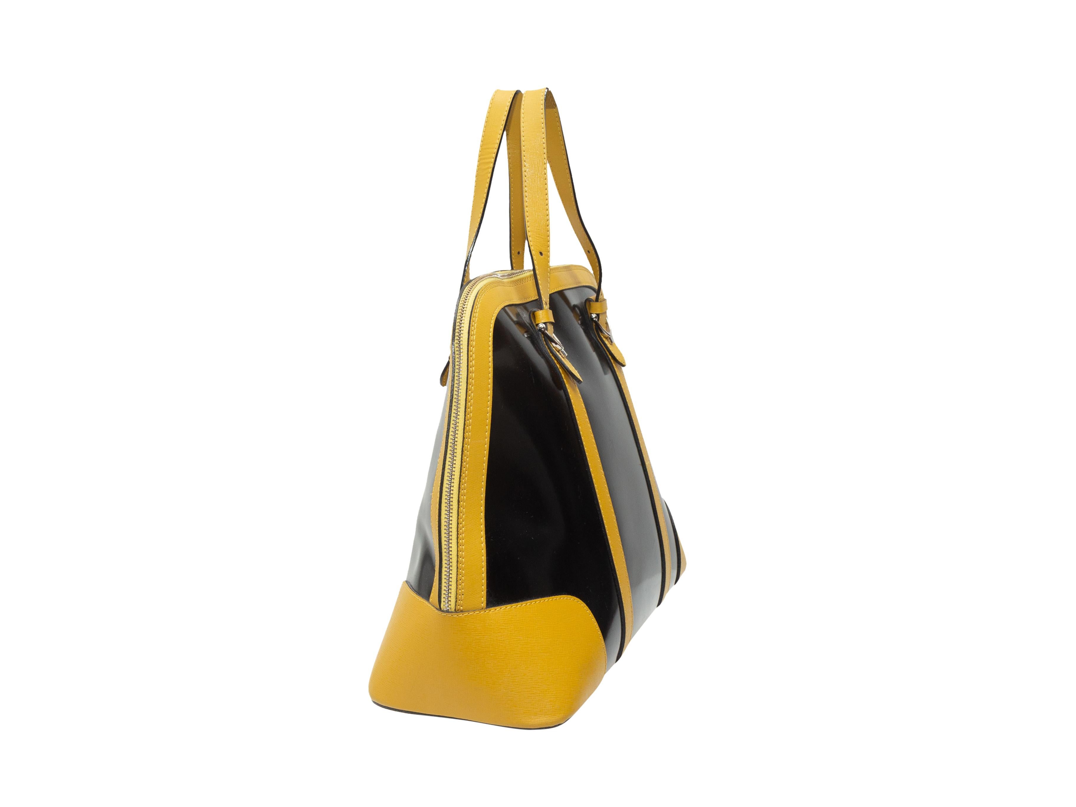 Product details: Black and yellow leather handbag by Pulicati. Silver-tone hardware. Interior zip pocket. Dual top handles featuring buckle accents. Zip closure at top. 15