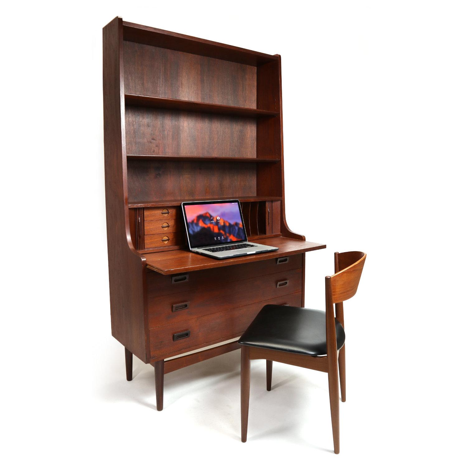 Borge Mogensen early Mid-Century Modern Danish teak desk. The stately piece has a deep red-orange patina from over half a century of age. We seldom find these early pieces these days. Maximize utility with this piece. It is simultaneously a bookcase