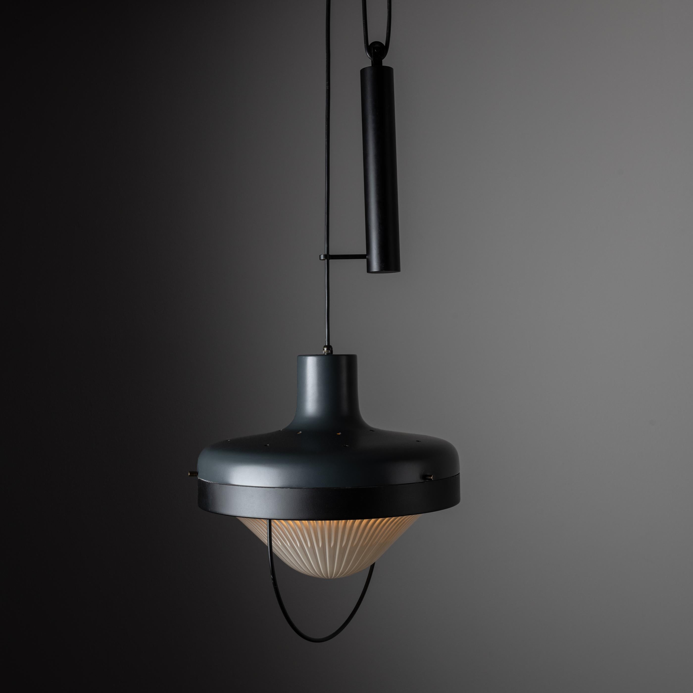 Pulley ceiling light by Greco. Manufactured and designed in Italy circa 1950. Circular matte finish ceiling fixture with beveled dew drop glass diffuser. Includes adjustable pulley system for desired height. We recommend using one E27 40W maximum