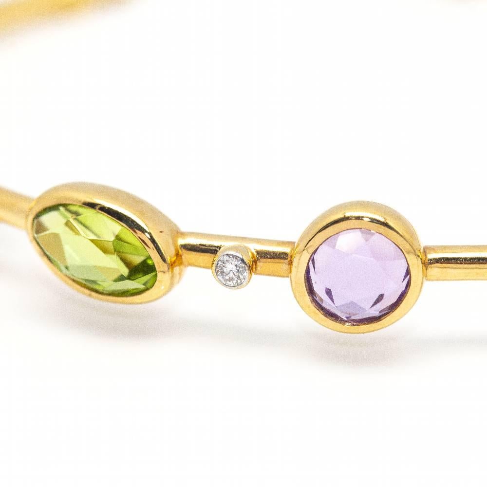 Rigid bracelet in Yellow Gold, Diamonds and gems for women  Fumme Quartz, Peridot, Amethyst, Topaz and Fumme Quartz interspersed with Brilliant cut Diamonds  18 kt Yellow Gold.  10.86 grams  Carabiner closure, fits two sizes  Measurements: Width 6cm