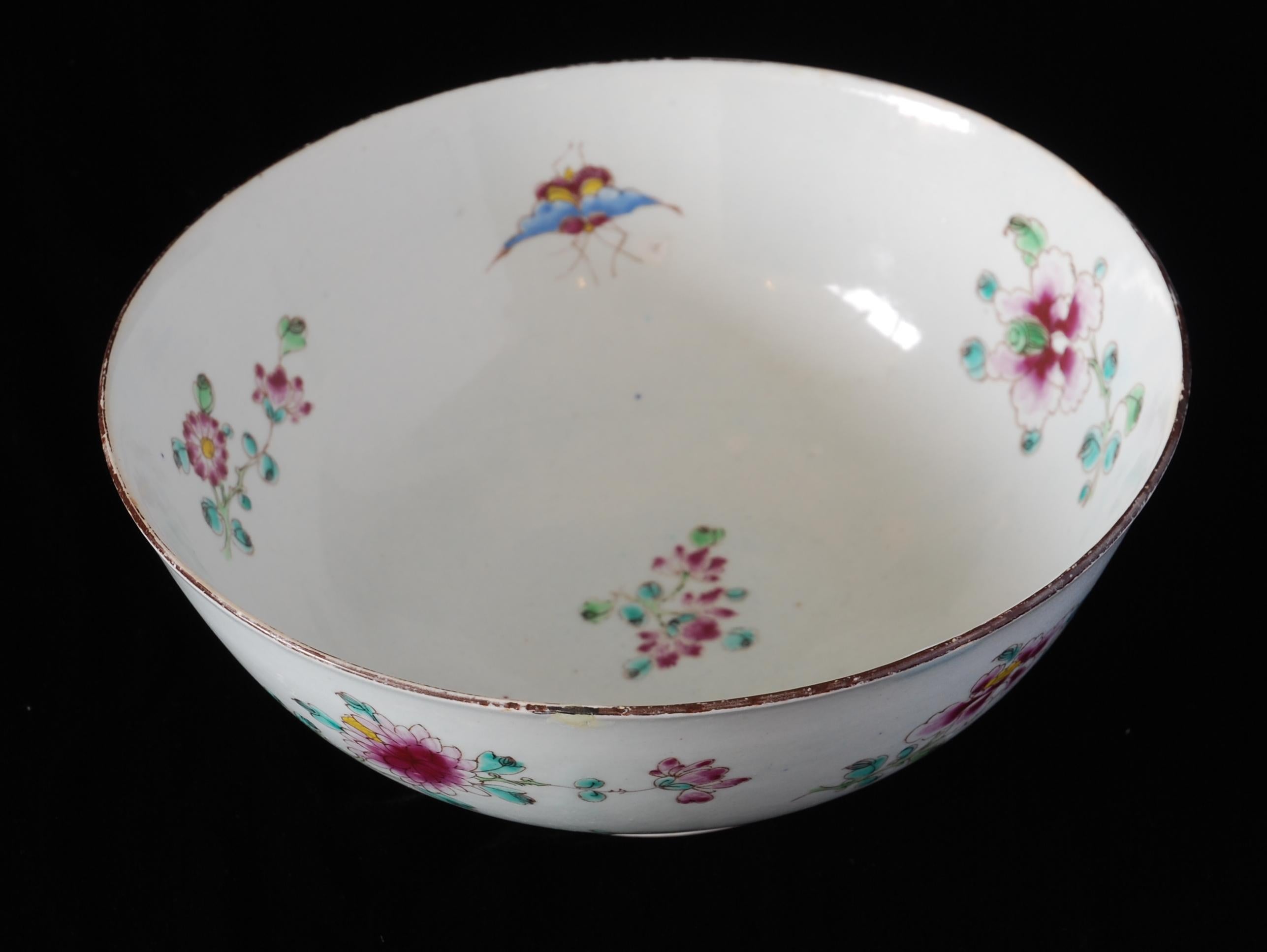 A rather splendid punch bowl from the Bow Porcelain Factory, enameled with flowers and insects in the Famille Rose style. A good size, at almost nine inches in diameter.

Famille Rose is a type of Chinese porcelain decoration that was first