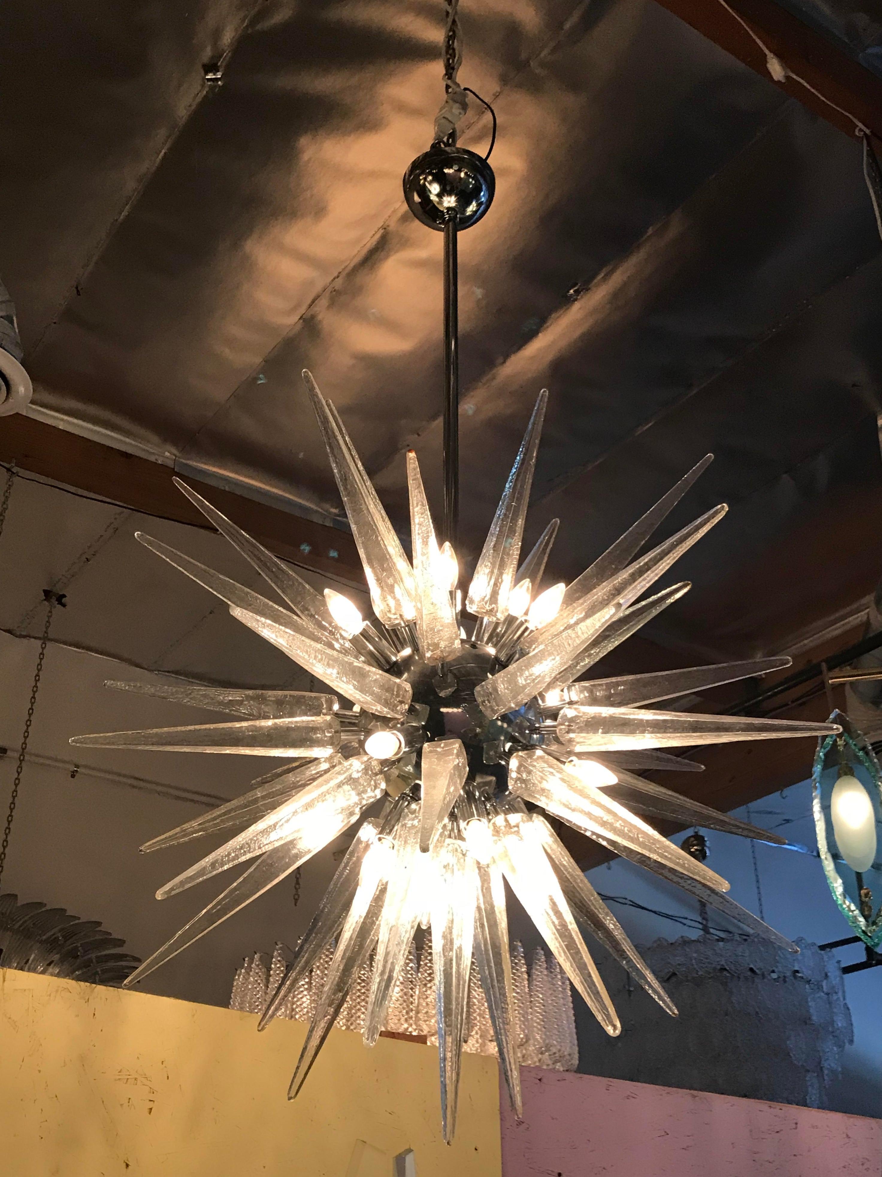 Italian modern Sputnik chandelier with clear Murano glass shards spikes, mounted on chrome metal frame / designed by Fabio Bergomi for Fabio Ltd, made in Italy
16-light / E12 or E14 type / max 40W each
Measures: Diameter 35 inches, height 55 inches