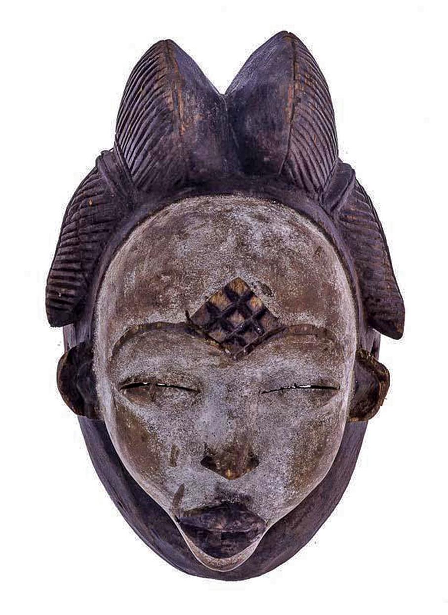 Beautiful African art mask in carved wood from Gabon, 20th century. It belongs to the Punu ethnic group, coming from Gabon.
This mask is carved in wood, representing female face bleached with ocher kaolin and traces of color. It shows the typical