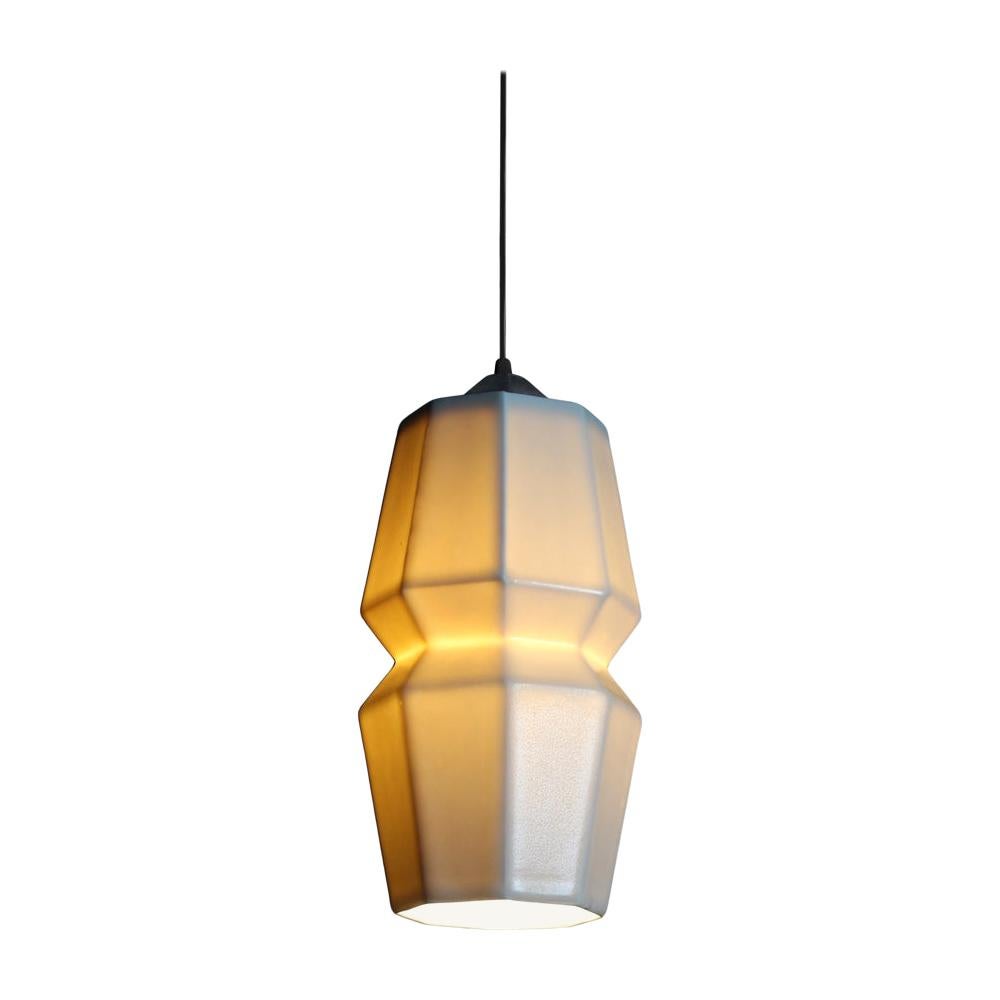 9 inch hanging pendant light from the tessellation group, this hanging pendant emits a soft, elegant glow through a translucent geometric porcelain shade, shining direct downward light through the open base. It’s the perfect modern porcelain