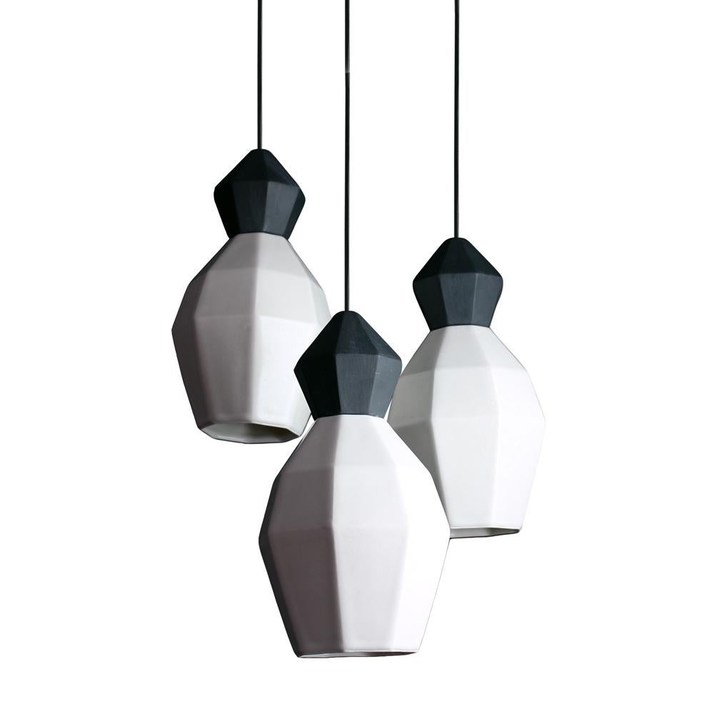 Create an atmospheric glow in your space with the small clustered hanging pendant lamps from the Extension collection. This cluster includes three of the small pendants, with geometric, translucent porcelain shades that diffuse light into an ambient