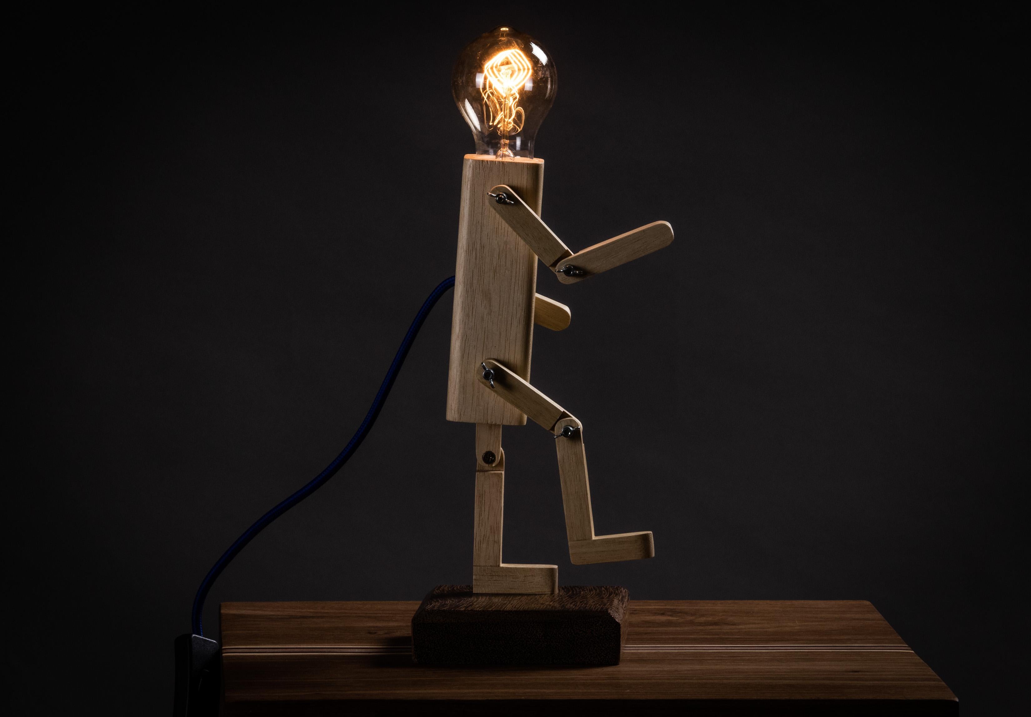 Playful and articulated lamp, made of solid caixeta and jequitibá wood, allowing for numerous movements and positions. The dark version is charred using the Japanese technique Shou Sugi Ban.50