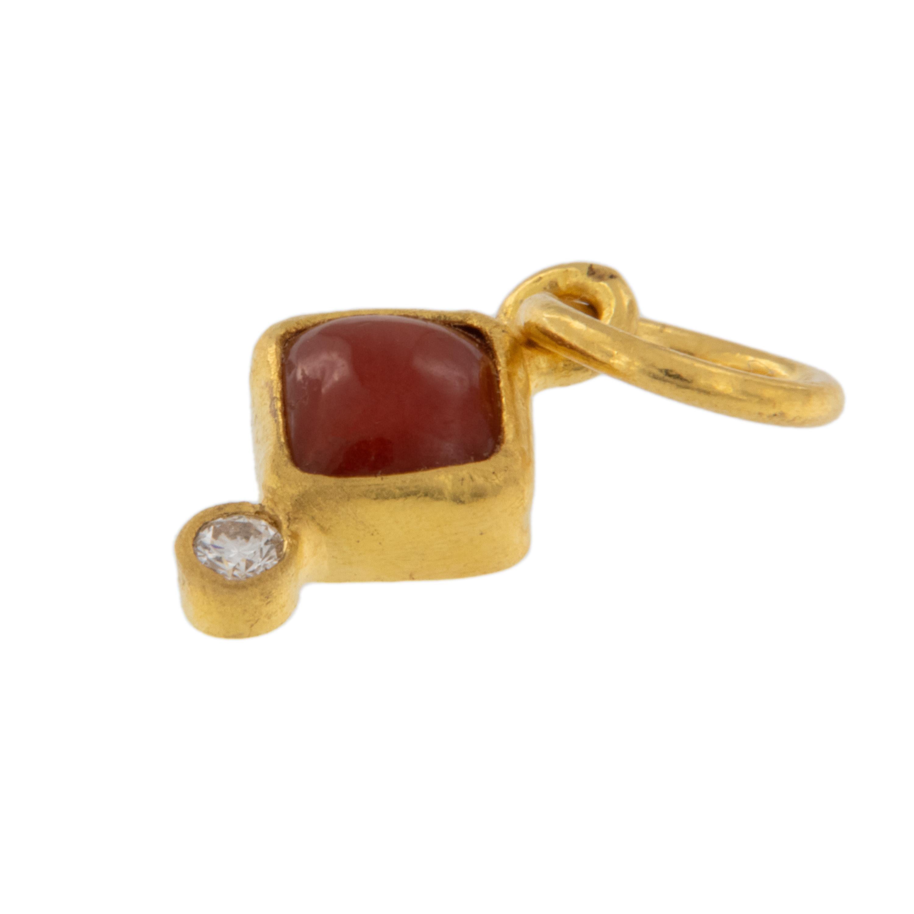 Rarest of all the golds, 24 karat gold is valued by all discerning investors. With it's unmistakable warm yellow color & textured finish this pendant / charm features a diamond shaped coral = 0.30 Carats perfectly punctuated with a round diamond =