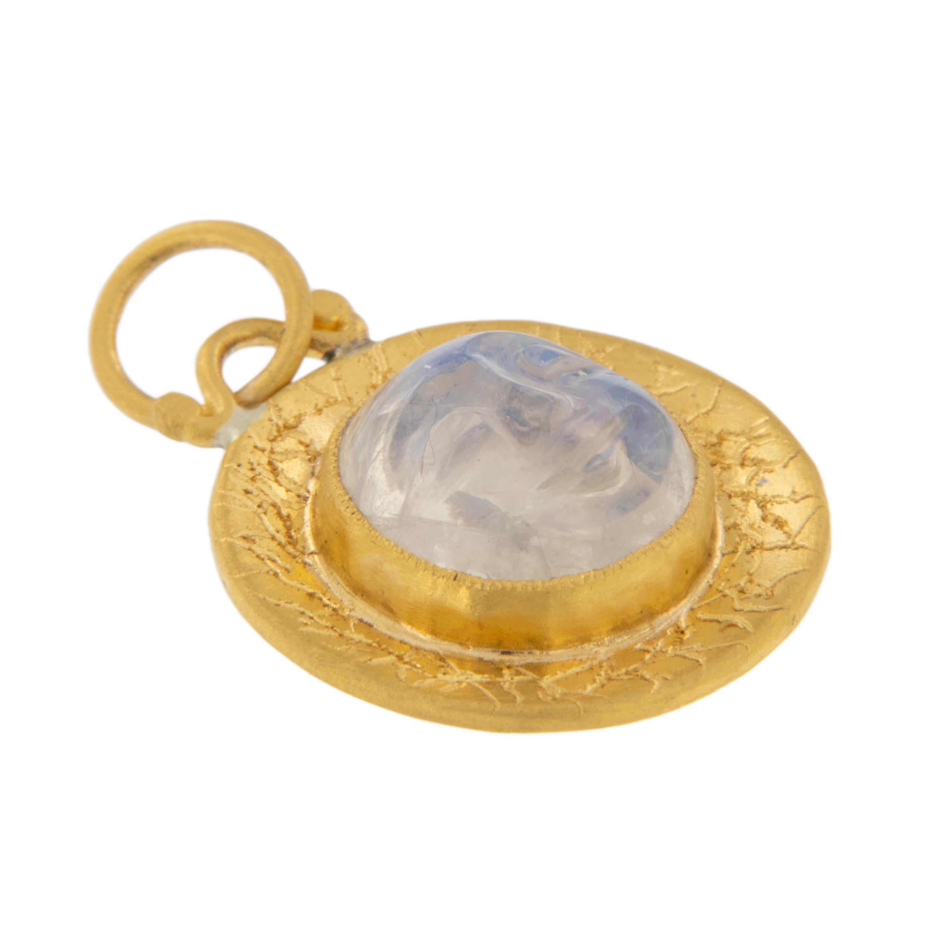 Rarest of all the golds, 24 karat gold is valued by all discerning investors. With it's unmistakable warm yellow color & hammered finish this adorable pendant / charm centered around a lovely carved moonface out of moonstone is just charming. The