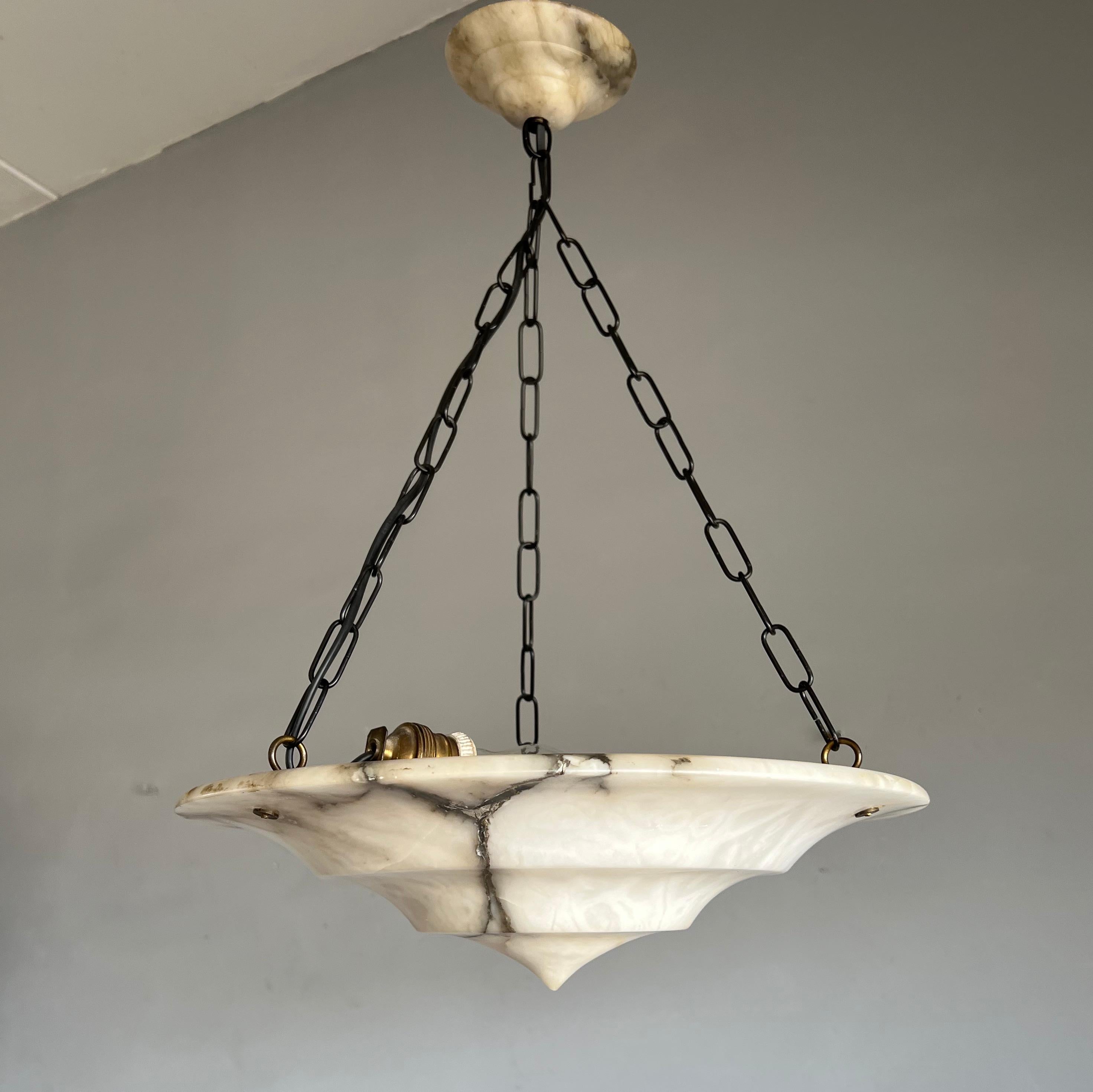 Unique and practical size, alabaster pendant of great quality and design.

This unique Art Deco fixture from the heydays of the European Art Deco era will light up both your days and evenings. Its remarkable, circular and layered shade is all hand