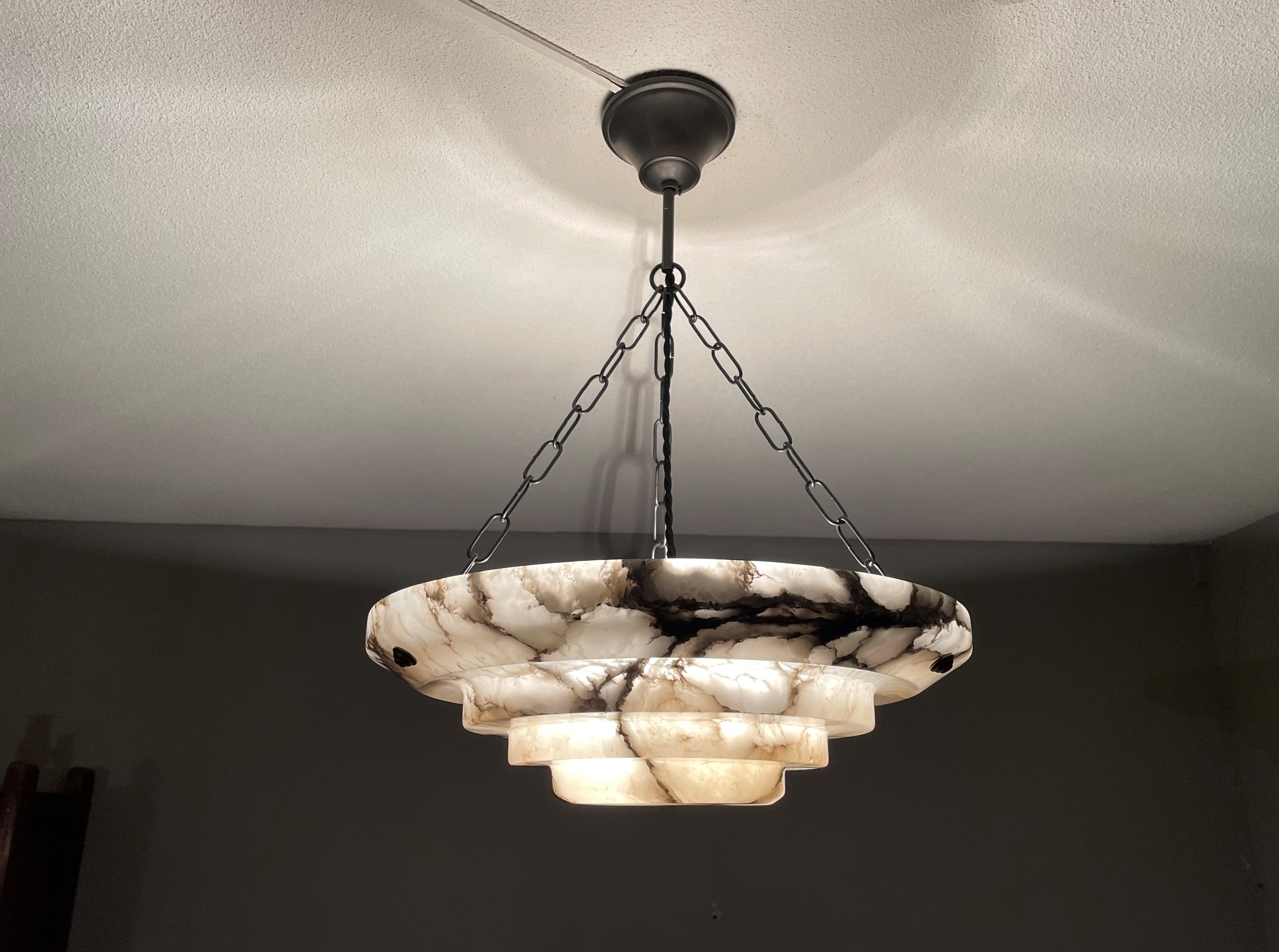 Unique and good size, alabaster pendant / flush mount of great quality and mint condition.

This unique Art Deco fixture from the heydays of the European Art Deco era will light up both your days and evenings. Its remarkable, circular and layered