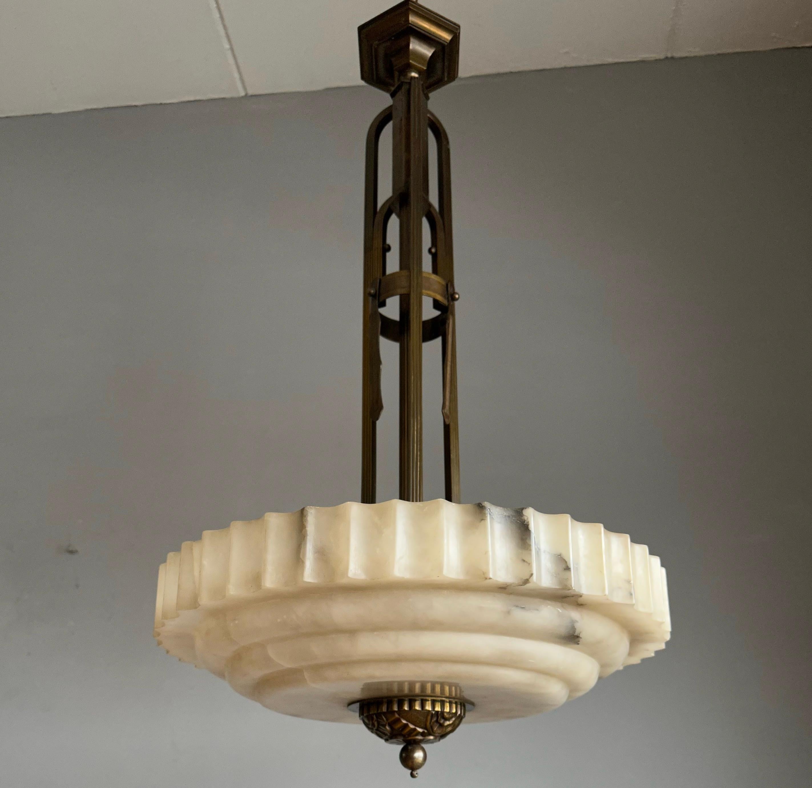Unique and good size, alabaster chandelier of great quality and condition.

This unique Art Deco fixture from the heydays of the European Art Deco era is another one of our recent great finds. Its remarkable, circular and layered shade is all hand