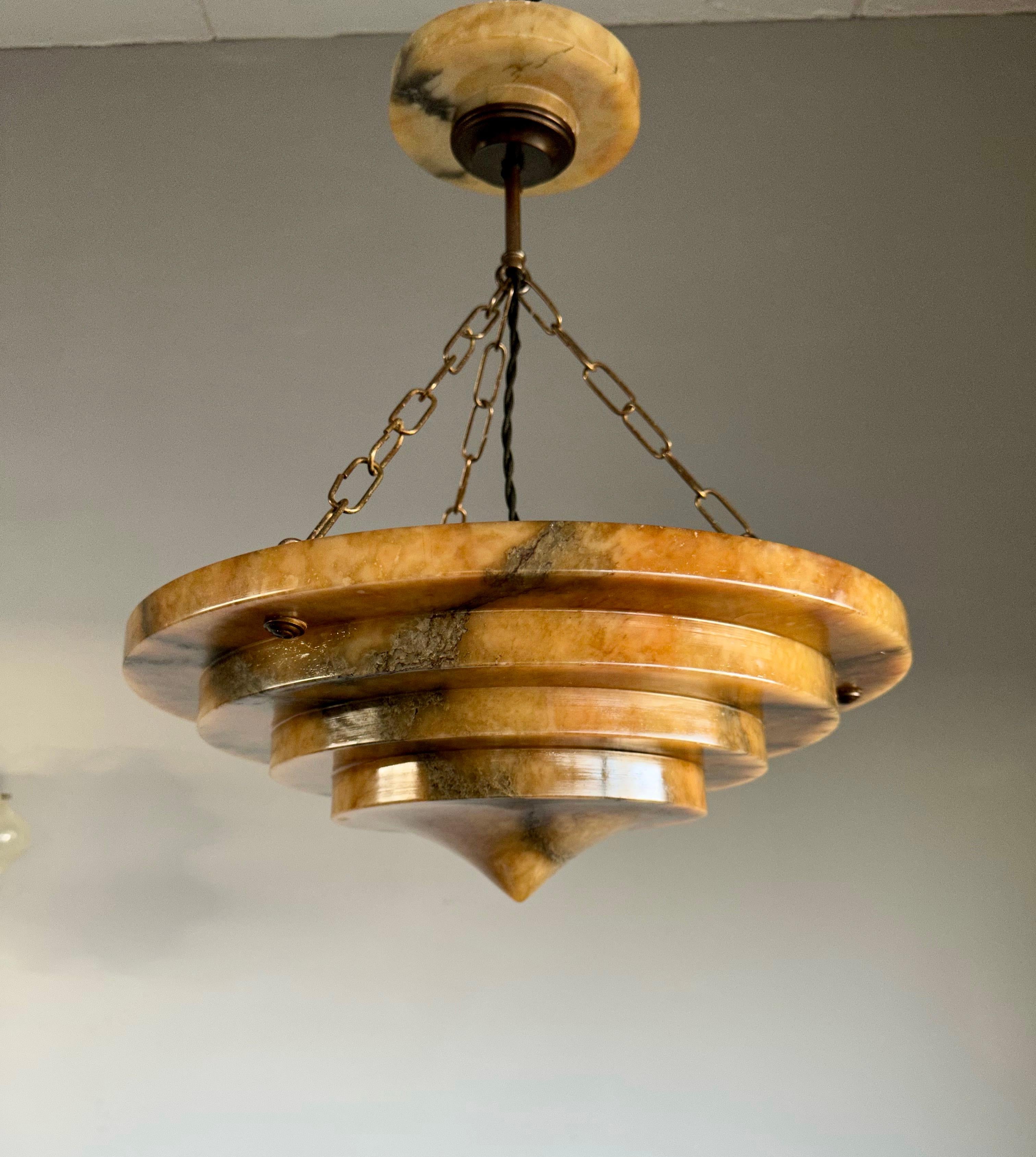 Unique and very stylish, mint condition and warm color alabaster pendant of great quality and design.

This unique Art Deco fixture from the heydays of the European Art Deco era is another one of our recent great finds and it too will light up both