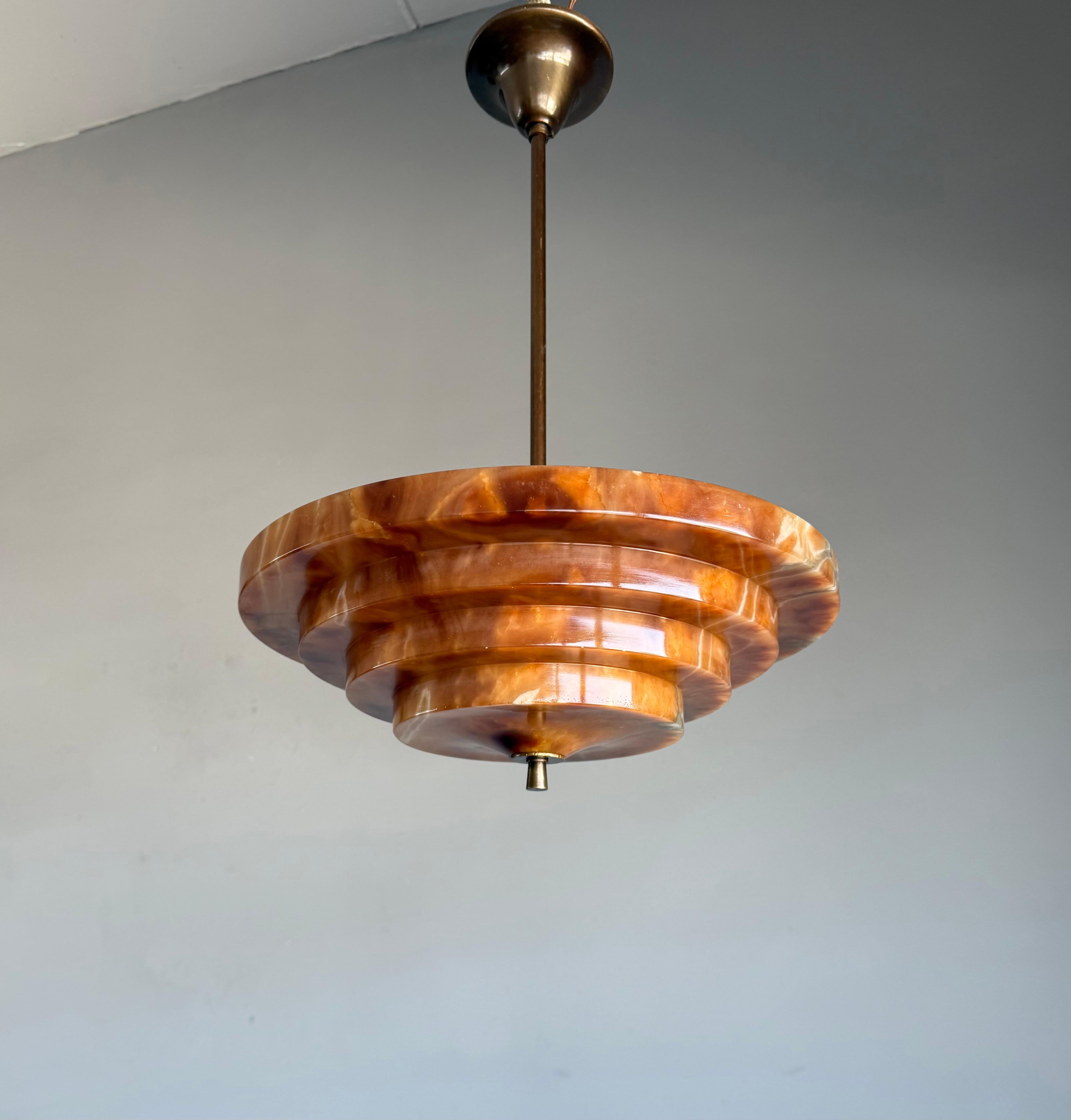 Rare and very stylish, top condition and warm color alabaster 3-light pendant of great quality and design.

This rare Art Deco fixture from the heydays of the European Art Deco era is another one of our recent great finds and it too will light up