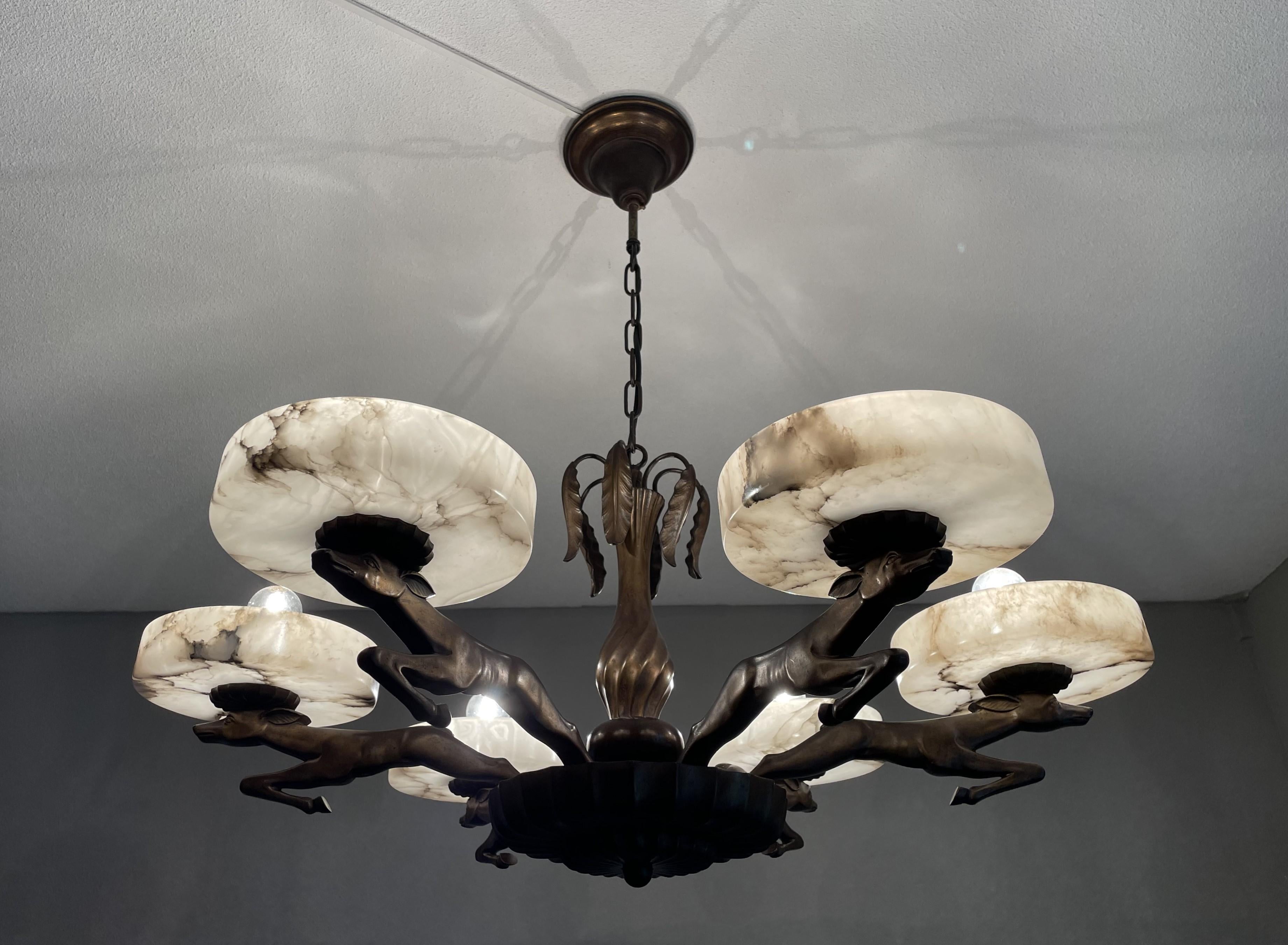 Exclusive bronze and alabaster, pure Art Deco pendant light for the perfect atmosphere.

If you are looking for an awesome light fixture to grace your living space then this antique Art Deco chandelier from the earliest years of the 1900s could very