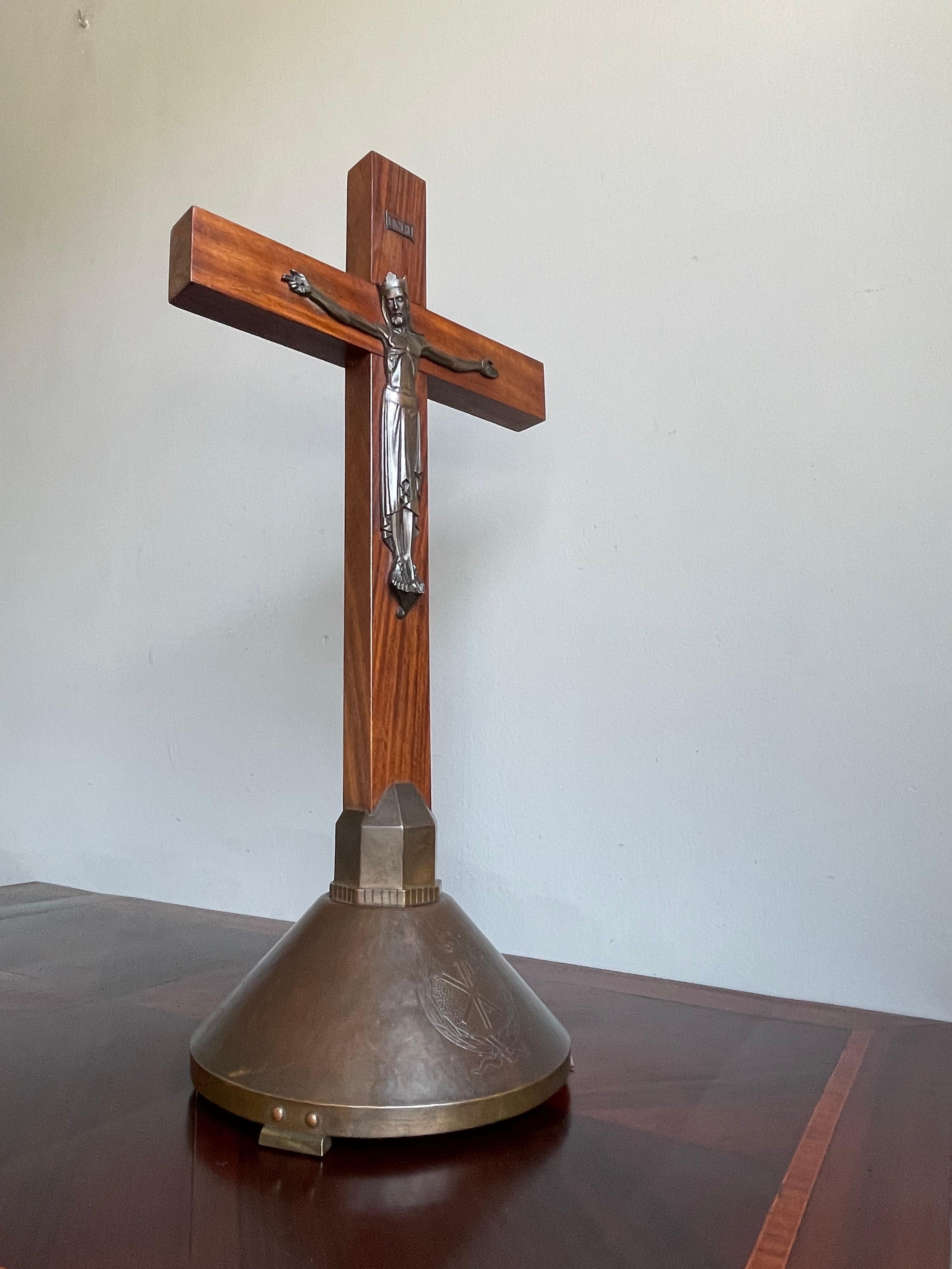 Marked altar crucifix with a brass base with Christogram and a bronze corpus with a Gothic crown.

For us the most powerful statement will always be 'the truth will set you free'. It is what we have learned most from the life of Christ and of His