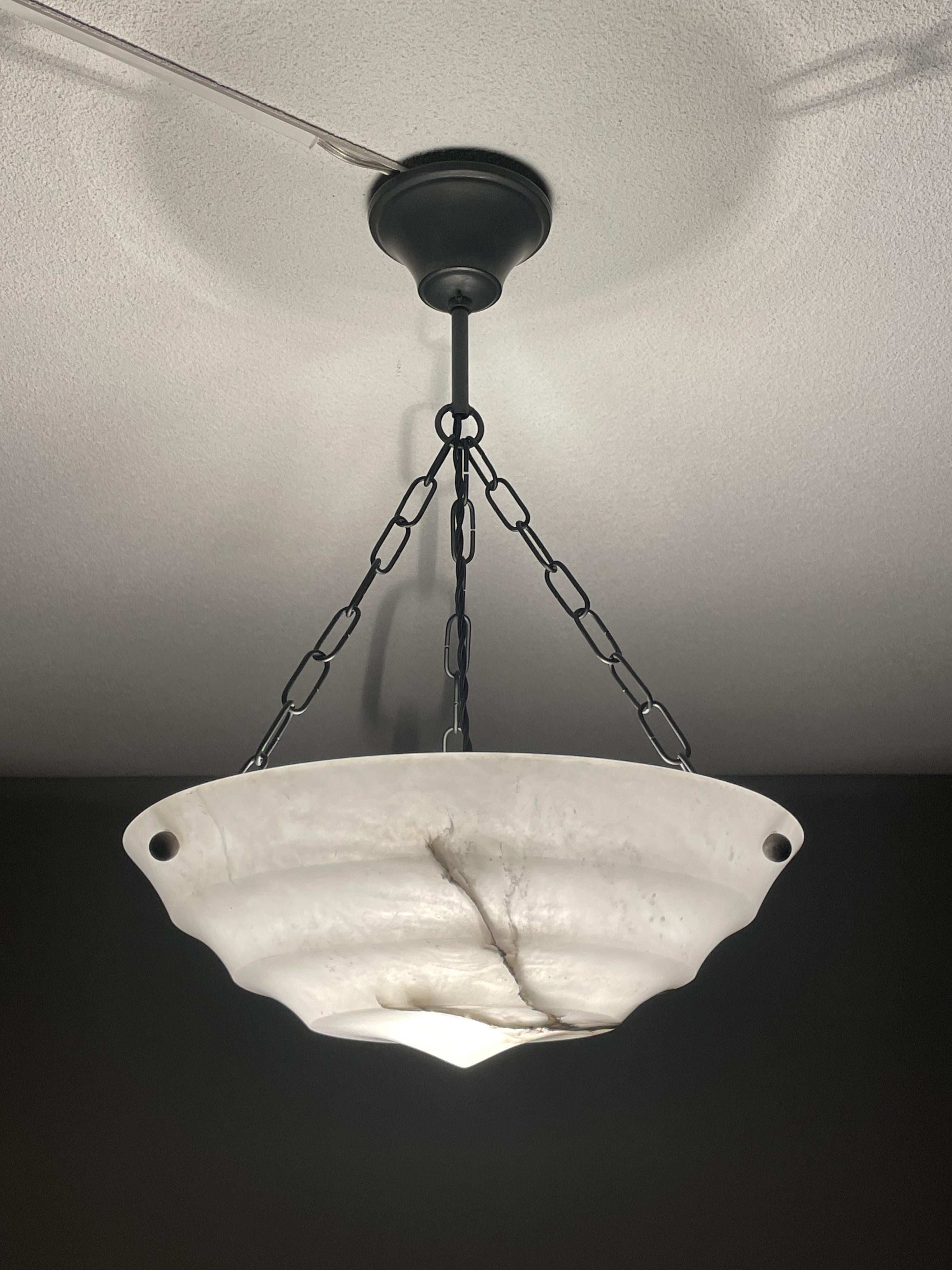 Timeless alabaster pendant for a smaller room, entry hall or bedroom.

This rare fixture from the heydays of the European Art Deco era could soon be lighting up your days and evenings. Its remarkable, circular and layered shade is all hand carved